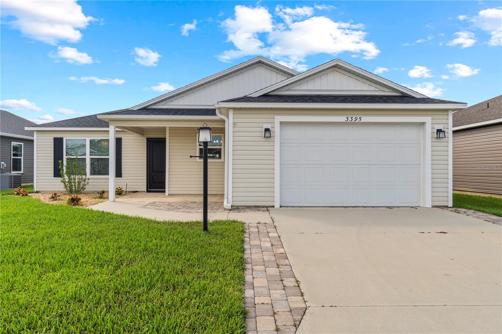 Located in the highly sought-after Villages of DeLuna, this three-bedroom, two-bath cottage home blends desirable upgrades with a prime location near Brownwood Paddock Square. The exterior showcases a widened paver driveway, lush landscaping with Robellini palms, and rear gutters. Inside, every room features a ceiling fan with upgraded light kits, the laundry offers built-in cabinetry, and the primary bath includes a frameless glass shower door and handheld wand. Gas appliances add efficiency, and bedroom three features a tinted window for added comfort. A screened lanai overlooks landscaping planned for future privacy. Enjoy golf cart access to pools, pickleball courts, recreation centers, and neighborhood events. With a lower annual bond and pricing below similar models, this home offers comfort, convenience, and the lifestyle The Villages is known for.
