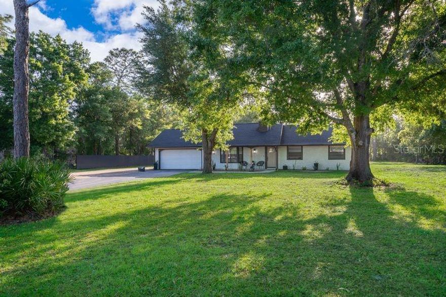 Discover the perfect blend of modern comfort, spacious living, and versatile income potential on this high-and-dry 2.43-acres lot right in the heart of town. The beautifully remodeled main house features 3 bedrooms and 2 bathrooms with thoughtful upgrades throughout. A brand-new roof (2022) and updated plumbing provide peace of mind, while the gourmet kitchen impresses with high-end soft-close cabinetry, sleek quartz countertops, and newer stainless steel appliances. Both bathrooms have been completely refreshed with new shower and floor tiles. Cozy up by the handsome wood-burning fireplace in the living room or step outside to the expansive porch—ideal for entertaining family and friends in the fresh Florida air.Separate from the main home, the detached in-law suite offers 2 additional bedrooms, 1 bathroom, and its own full kitchen—all beautifully tiled for easy living. Enjoy relaxing or hosting on the suite’s spacious private patio. Between the two structures, the generous brick-paver area creates an outstanding outdoor entertaining space perfect for large gatherings, barbecues, or simply unwinding.Per county regulations, there’s even room to add another ADU and a cottage, giving you incredible flexibility for extended family, guests, or future investment.Conveniently located just minutes from Florida’s Turnpike, the VA Hospital, Lake Nona’s vibrant community, and Orlando International Airport—this property offers the rare combination of privacy, space, and unbeatable access to everything Central Florida has to offer.Whether you’re seeking a primary residence with multi-generational living options or a smart investment property, this turnkey home checks every box.