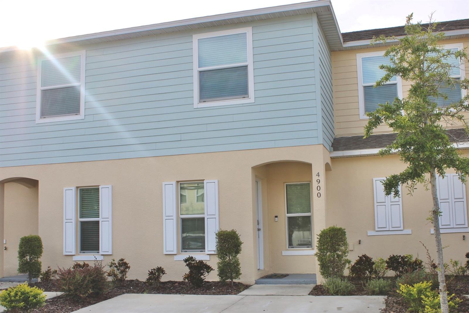Welcome to Fiesta Key! This beautiful 3-bedroom, 2.5-bath townhouse, built in 2022, offers modern living in a gated resort-style community. It features an open floor plan with quartz countertops, stainless steel appliances, and tile and carpet flooring inside, plus laminate flooring in the upgraded patio. The spacious master suite includes a walk-in closet and double vanity. Enjoy Florida living with a private screened patio, perfect for relaxing or entertaining. The community offers a pool, fitness center, tennis courts, and clubhouse, just minutes from Disney, shopping, and restaurants. Ideal as a primary residence, vacation home, or investment property with short-term rental potential.