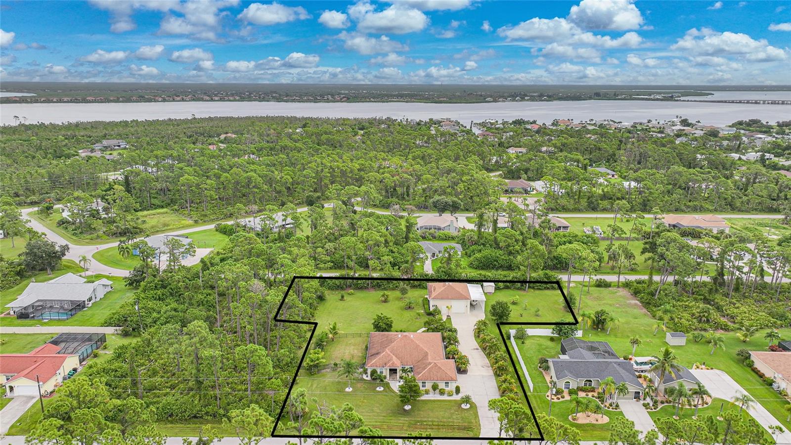 ALL THE SPACE YOU NEED! This property is five lots spreading OVER an acre of land in Gulf Cove at 50,000 square feet with NO HOA and NO DEED RESTRICTIONS. Featuring a HUGE 36x40 DETACHED GARAGE that can fit multiple boats, cars and any other toys you may have, as well an office and bathroom. There is also an RV Carport attached with a 50 AMP POWER HOOK UP. The main house by itself is filled with tons of custom updates and features a den/BONUS ROOM that could even serve as a 4TH BEDROOM and another HUGE garage that is very deep that can fit EVEN MORE TOYS IF NEEDED. The property is located just up the road from Gulf Cove's BOAT RAMP that can be accessed for a modest $75 a year granting GULF ACCESS. The property is outfitted with custom wood flooring and feels very airy with tall cathedral ceilings in the living room. The GOURMET KITCHEN is super spacious and features QUARTZ COUNTERTOPS, PULL OUT DRAWERS, CUSTOM WOOD/SOFT CLOSE CABINETS, STAINLESS STEEL APPLIANCES with an ITALIAN GAS RANGE, DRY BAR and charming UNDER CABINET LIGHTING. The Primary Bedroom boasts a tray ceiling and a very large walk-in closet and French doors to the back patio. Primary Bathroom features a HEATED BIDET TOILET, QUARTZ COUNTERTOPS, WALK-IN SHOWER with BENCH and more. The secondary bedrooms are VERY LARGE and have updated tile flooring with one bedroom featuring a HUGE WALK-IN CLOSET and DOORS TO THE PATIO. Enjoy meticulously maintained home updated with small features that go a long way like dimmers on the lights switches, extra-large ceiling fans, crown molding throughout, commercial venting above the range and MORE. The Side yard has a 50x50 IRON FENCE. The DETACHED GARAGE can fit up to FIVE CARS and comes with a full bathroom and PRIVATE OFFICE that can be repurposed to whatever you would like to use it for. There is also an additional STORAGE SHED providing even more space. Property is hooked up to PUBLIC WATER. The homes back patio has a convenient walkway to the detached garage providing easy access. Outdoor shower included. on the side of the home. Lots of charming tropical plants all around the property. Enjoy close proximity to Boca Grande Beach, Manasota Key Beach, Historic Dearborn Street, Historic Downtown Punta Gorda, Wellen Park, Tampa Ray and Atlanta Braves Spring Training. This property is also close to many restaurants, places to shop, doctor's offices, hospitals, farmers markets and MORE. Call your agent today. BE SURE TO ASK FOR THE FEATURE SHEET and VIEW THE 3D VIRTUAL TOUR ON ZILLOW.
