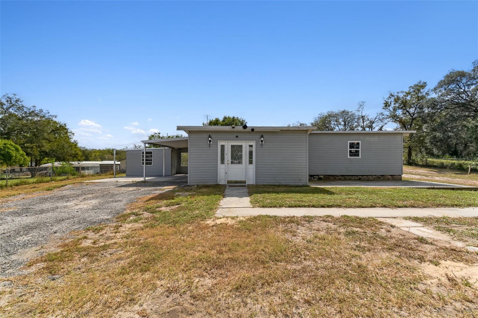 Discover this hidden gem in Dade City! This well-maintained and spacious 2-bedroom, 2-bath mobile home offers comfortable living with generously sized rooms and a versatile floor plan. A bonus room provides the perfect space for a potential 3rd bedroom, home office, or hobby room. Situated on an oversized lot, you'll have plenty of outdoor space to relax, garden, or entertain. The property also includes an attached storage room and workshop—ideal for tools, projects, or extra storage. RV parking is available, adding even more flexibility. Conveniently located close to shopping, dining, and other local amenities, this home blends charm, functionality, and convenience. Come see it today!