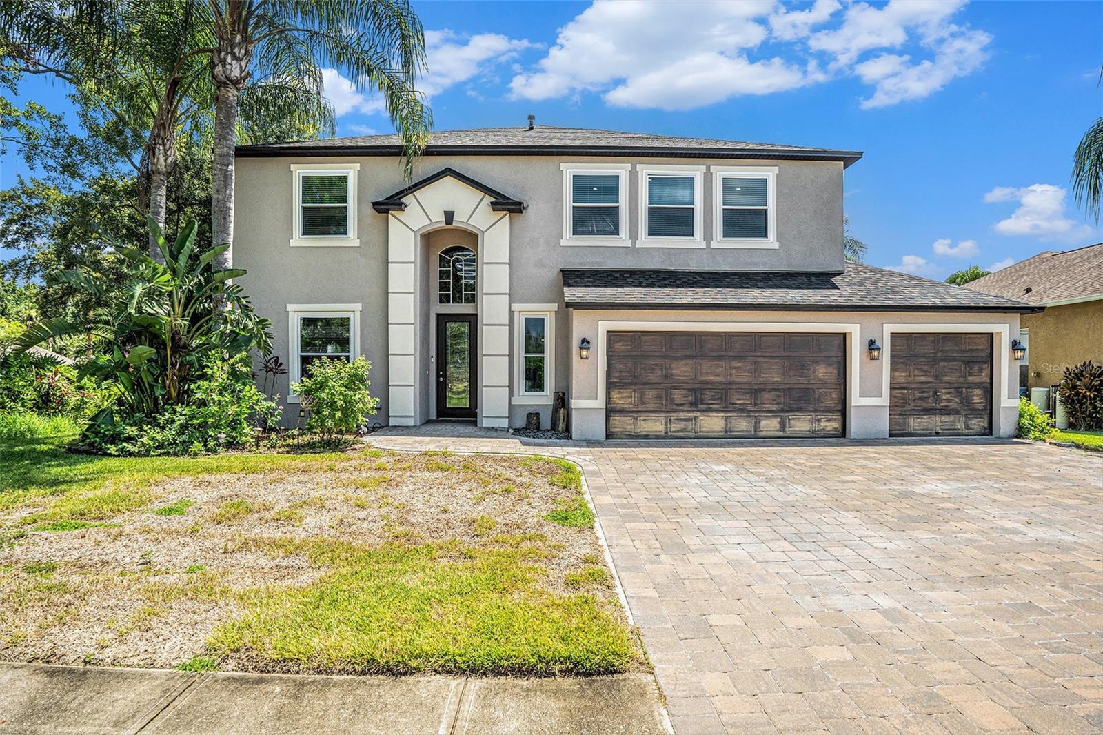Welcome to 2626 Millhopper Ave, a beautifully maintained 5-bedroom, 3.5-bathroom home located in a desirable gated community in the heart of Wesley Chapel. This spacious two-story home offers over 3,300 square feet of living space, perfect for families or those who love to entertain.
Step inside to find a bright and open floor plan with high ceilings, formal living and dining areas, and a large family room that opens to the kitchen. The kitchen features granite countertops, stainless steel appliances, a center island, and a breakfast nook overlooking the backyard.
The first-floor primary suite provides a peaceful retreat with a walk-in closet and a luxurious en-suite bathroom featuring dual vanities and a walk-in shower. Upstairs, you’ll find four additional generously sized bedrooms and a large loft—ideal for a game room, office, or second living area.
Enjoy outdoor living with a covered lanai and a fully fenced backyard. The 3-car garage offers ample space for vehicles and storage.
Conveniently located near top-rated schools, Wiregrass Mall, restaurants, and major highways, this home provides the perfect balance of comfort and accessibility.
Key Features:
5 Bedrooms | 3.5 Bathrooms
3-Car Garage
Over 3,300 Sq Ft
Gated Community
First-Floor Primary Suite
Granite Countertops & Stainless Steel Appliances
Large Loft Area
Fenced Backyard with Covered Lanai