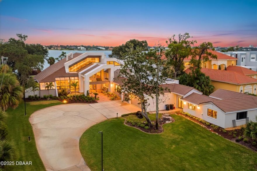 Discover unparalleled luxury in this exquisitely appointed 7-bedroom, 8.5-bath, 3-car garage riverfront estate with an impressive in-law suite! Set on 1.33 acres of meticulously landscaped grounds, this magnificent property seamlessly blends traditional charm with modern sophistication, offering a truly unique and lavish living experience. Upon entering, you are immediately captivated by the flood of natural light that bathes the home's interior. The grandeur of the main living area, boasting soaring 30-foot ceilings, creates an inviting and spacious atmosphere, while the thoughtfully designed floor plan ensures ample living space for both relaxation and entertainment. Inside, the home features a plethora of living areas, including three distinct living spaces on the lower level...

... each adorned with its own cozy fireplace. A formal dining room, a stylish wet bar, and two separate office areas further enhance the home's appeal. Three full kitchens, including the 18'x17' chef's kitchen in the main living area, are a chef's dream, complete with exquisite granite countertops, a central granite island, and a charming breakfast nook. The lower level also boasts four bedrooms, including two within the main living area, each with its own private bath. Upstairs, three additional bedrooms, each with its own private bath, await, including the opulent primary en suite, which features a spacious spa-like bath and access to a captivating walk-out balcony overlooking the river. The in-law suite on the lower level is a private retreat, offering a comfortable living room, a cozy dining area, a full kitchen, and two bedrooms, one of which includes a private full bath. Throughout the home, luxurious 24"x24" marble tile adds a touch of elegance and sophistication. Outside, the full bath, inviting pool, expansive patio, and lush green space create an idyllic setting for outdoor gatherings and entertaining. With your own private dock, you can enjoy watching dolphins and manatees while taking in the panoramic views of the Intracoastal Waterway. This exceptional riverfront estate offers a lifestyle of unparalleled luxury and sophistication, presenting a rare opportunity to own a truly remarkable residence in a highly sought-after location. Square footage received from tax rolls. All information recorded in the MLS intended to be accurate but cannot be guaranteed.