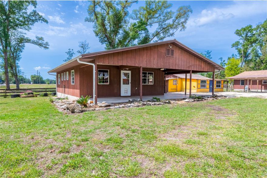 Single-Family Home with Guest House or Multi-Family / Income-Producing Opportunity in Chiefland, Florida. Beautiful country living with income-producing potential! Don’t miss this rare opportunity to own a versatile property featuring two cabin-style homes on approximately one acre ideal for single-family living with a guest house, multi-family use, or rental income. The property is fully fenced and cross-fenced, offering flexibility for livestock or additional use. In total, there are seven structures: two homes, a clubhouse, barn, shop, and two carports. Utilities are well established with three septic systems, one well, and underground electric throughout. Each home has its own 200-amp panel, while the clubhouse and shop have 100-amp panels, and the barn has a 110-amp panel. The well has been recently upgraded with a new pump and tank and provides excellent water. The land adds both beauty and value, featuring mature pecan, orange, and lemon trees, along with young pomegranate and kumquat trees. An electric gate at the entrance enhances both convenience and security. Both homes feature raised concrete foundations with wood framing, reflecting solid construction and durability. The front home offers a two-bedroom, one-bath layout with a utility room, functional kitchen, and comfortable living area, along with spacious front and side porches. Totaling 1,554 sq ft (984 sq ft H/C), it includes an efficient gas fireplace for heating and a wall A/C unit for cooling. While central air was previously installed, the ductwork remains, allowing for easy reinstallation if desired. The back home includes two bedrooms, one bath, a kitchen, and combined living/dining area, with both front and back porches. Totaling 856 sq ft (656 sq ft H/C), it is equipped with a wall A/C and electric heater for reliable comfort. A new roof installed in January 2026 adds peace of mind. High-speed Wi-Fiber internet in both homes. The approximately 1,000 sq ft clubhouse, originally a deer camp on the Suwannee River and relocated to the property, includes a shower, sink, and toilet, along with its own septic system and 100-amp panel. While it could use some TLC, it remains functional and offers potential for additional living space or other uses. Enjoy peaceful Levy County living just minutes from the Suwannee River, approximately 20 minutes to the Gulf, and only 6 miles to Chiefland for shopping and everyday needs. Located within a rural commercial node, this property could present future rezoning potential, further enhancing its investment value. Whether you’re looking for a primary residence with a guest home, a multi-family setup, or an income-producing investment, this unique property delivers flexibility, functionality, and long-term potential.
Agent Comments: Dimensions, square footage and other property details were obtained from DCPA and should be verified to satisfy buyer. It is buyer's responsibility to verify, by survey, exact dimensions, acreage, corner markers and elevation. Buyer should also complete their due diligence to check zoning and allowable uses of property with local governing authorities. Red boundary lines are estimates only.