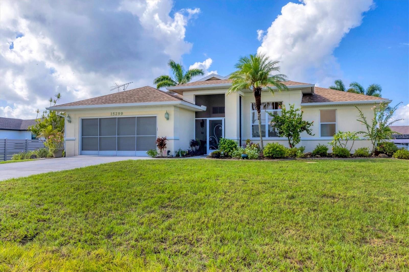 Attention sail boating enthusiasts! This stunning waterfront home offers everything you need to fully embrace the boating lifestyle. With a highly desirable southern rear exposure, this pool home is nestled on sailboat water, providing you with direct access to open waters. Featuring a concrete seawall and an expansive 30-foot dock complete with electric, water hookups, and a 24,000 lb. boat lift, it's the perfect setup for launching your boat and setting sail at a moment's notice. A beautifully stamped concrete walkway leads you from the home directly to the dock, creating a seamless transition from land to water. After a day of boating, you can relax in the spacious, heated pool and extended lanai area offering the perfect setting for relaxation or entertainment, all which is enclosed in a no-see-um screened enclosure for comfort year-round. Relish in the expansive pool & water views from inside with 16’ wide pocket sliders in the main living area. The open-concept interior features a spacious living room that flows into a kitchen that is both functional and stylish, complete with decorative tile backsplash, glass-front cabinetry, and plenty of space for gatherings. The dining room adds an extra touch of sophistication with its tray ceiling and crown molding, creating the perfect space for entertaining family and friends. The luxurious master suite is a true retreat, offering both a walk-in closet and a second closet, as well as a tray ceiling with crown molding. The master bath is designed for relaxation and accessibility, with a large walk-in shower, a separate soaking tub, dual sinks, and a private commode area. Bedroom #2 offers direct access to the pool and lanai, making it ideal for guests or family members, and includes a spacious walk-in closet. High ceilings throughout provide an airy expansive feel. This home has been meticulously updated to ensure long-term value and modern comfort, including a newly sodded lawn (July 2025), a new range and microwave (2025), garage door opener (2024). dishwasher (2023), A/C system (2023), pool heater (2023), water heater (2023), front entry and master bedroom impact-rated doors (2023), new roof & soffits (2022), blown-in insulation for entire home including garage (2022), updated electrical panel (2017), and dual capacity irrigation (canal/city water) system (2017) for ongoing savings. The interior utility room provides even more convenience, with front-load laundry machines, a utility sink, and ample storage in two closets. Professionally landscaped exterior is complimented with curbing. Every detail of this home has been carefully curated to enhance the boating lifestyle and offer unmatched comfort. It’s the perfect place for those who want to experience the best of life on the water while enjoying the comfort of a modern, updated home.