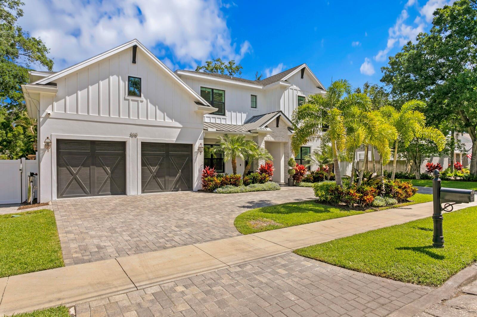 Newer TB Homes Farmhouse in Palma Ceia. The stately home spans over an 100x100 Double Lot! 2 story block construction, Impact rated windows & sprayfoam insulation. 3 car garage, Circular Driveway, Screened in lanai with heated/saltwater pool & outdoor kitchen. As you enter the foyer you have a classic layout w/a formal dining room to one side & a parlor to the other (Dacor wine dispenser, 30" wine fridge tower, wainscoting, built-in cabinetry & gas fireplace). Great room w/stained beams is open to the Kitchen (Professional Series Sub-Zero Wolf appliances, quartz counters/matching quartz backsplash, custom cabinets stacked to ceiling, pot-filler & concrete farm sink) w/a sunny breakfast nook overlooking the back yard. Behind the kitchen sits the perfect home office off of the mud-room (custom cabinetry) w/a powder bath nearby (tiled vanity feature wall) The office is completely built-out w/custom desk/cabinets/shelving. Topping off the 1st level is a guest suite/full bathroom. The 2nd floor holds jack-n-jill bedroom suites, an ensuite bedroom w/designer bath tiles, large laundry w/cabinetry/sink/storage & media room equipped w/a kitchenette (micro + fridge) & it's own private 1/2 bath. Upgrades include: Central Vac, Whole House Water Filtration System, Plantation Shutters, Custom Built-ins (office, media room, pantry & mud-station), Shiplap/Wainscotting/Feature Walls, Closet Built-ins throughout, Garage Shelving, Smooth Drywall, Designer Lighting, Solid Core Doors & Custom Oak Staircase. The Double Lot was Professionally Landscaped & Designed for function with Turf at the rear yard. Screened in Saltwater Heated Pool/Spa/Sun Shelf. Custom Pergola on Westside of property. Sport Court and Playhouse on the Eastside of property. Roosevelt/Coleman/Plant.