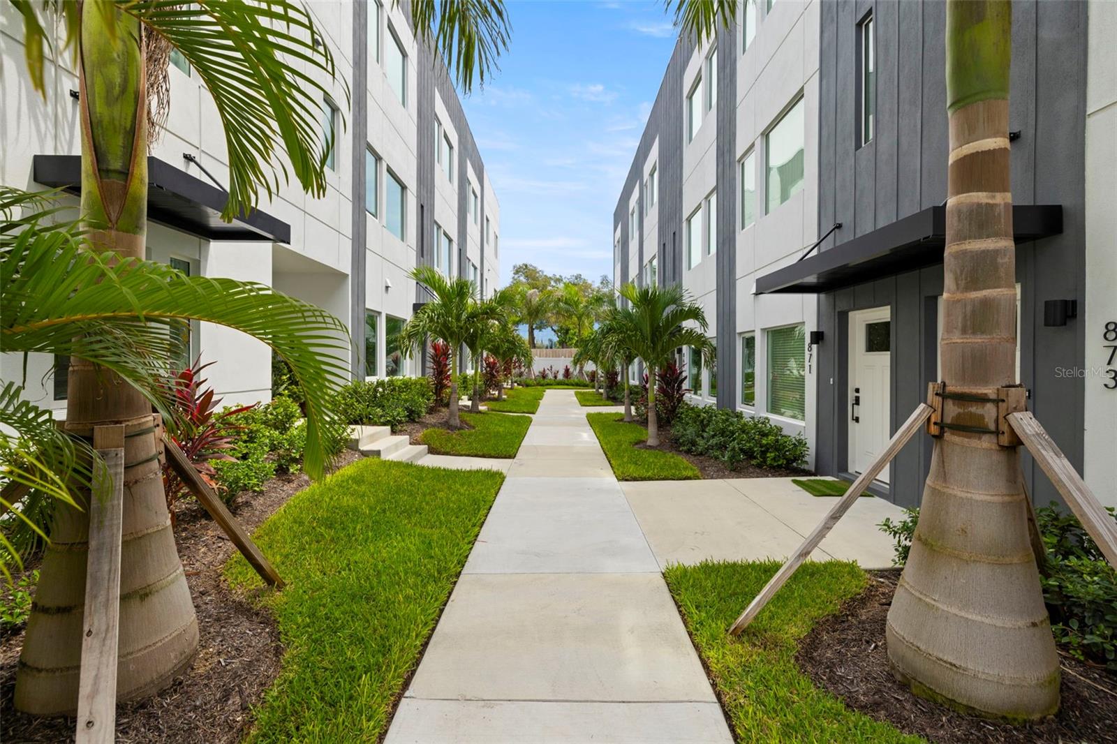 Live the vibrant urban lifestyle in this stylish and spacious 2-bedroom, 2.5-bathroom townhouse. Located in the heart of Downtown St. Petersburg, this residence offers the ultimate in convenience, comfort, and modern design.
This ALL-BLOCK luxury-residence is situated in a NON-FLOOD, NON-EVAC ZONE, with Hurricane IMPACT windows for ultimate peace of mind.
The lush landscaping is what you will see upon walking to the front entry way The first level features a versatile second bedroom with an en-suite bath with direct access to an oversized one-car-EV-ready garage complete with new epoxy flooring.
The spacious chef’s kitchen boasts quartz countertops with an oversized island with a WATERFALL countertop, a breakfast bar for four, and sleek, flat surface, European, soft close cabinetry with a striking marble herringbone tile backsplash. The appliances are ALL brand-new Bosch appliances, including a FIVE burned GAS oven, convection microwave, dishwasher, refrigerator AND wine refrigerator will complete this stylish and functioning space that is perfect for entertaining. The living space shares the floor with the gourmet kitchen and is large, comfortable with lots of natural light.
Retreat to the primary suite upstairs for ultimate relaxation where you'll find a brand-new, custom, walk-in closet with built-ins and stylish décor. A beautifully tiled ensuite bath with double sinks, custom LED mirrors, wood shelving and an extra-large walk-in shower. The washer and dryer room is conveniently located near the master bedroom. Also on the floor is a versatile loft space—perfect for a home office, creative studio, or workout zone. The entire townhome has custom roller-shade blinds that allow privacy and natural light.
The crown jewel of this residence is the private rooftop terrace. Imagine unwinding under the new sunshade, grilling with friends on the brand new, built-in 36-inch gas grill with stone countertops. Imagine mixing cocktails in the rooftop wet bar, watching the city views which often feature firework displays— all with the city skyline as your backdrop. This space isn’t just an amenity; it’s your urban oasis in the sky.
This exclusive 26-unit boutique community offers modern living just steps from everything downtown has to give. Imagine strolling to the St. Pete Pier, where 26 acres of breathtaking waterfront seamlessly blend with lush parks—creating the ultimate destination for biking, dining, shopping, concerts, and more. And the best part? You can walk to it all! From the moment you step inside, you'll feel the pride of ownership in every detail. SELLER IS LOOKING TO INCLUDE ALL FURNISHINGS - ALL WALL DECOR AND ALL TV'S (80" 70" & 65") IN THE SALE OF THIS PROPERTY.