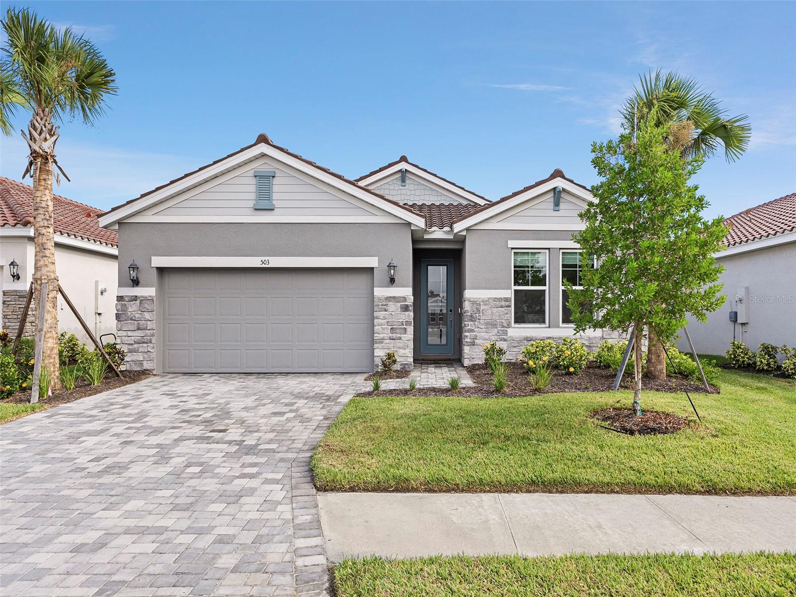 BUILT IN 2022 .. This well-designed three-bedroom, three-bathroom home has upgrades galore and is a must-see! Avoid the wait for new construction with this nearly-new home in the gated community of Venice Woodlands. Situated on a cul-de-sac, offering views of the preserved greenery. Boasting a gourmet kitchen that any chef would love, it features a magnificent central island, contemporary Whirlpool stainless steel appliances, and a custom backsplash. The wood plank tile flooring throughout all the living areas adds an elegant touch. The open layout is perfect for entertaining, while the flex space can be utilized as a home office or even a fourth bedroom. The master suite is an ideal retreat with an oversized walk-in closet and huge walk-in shower. Laundry Room includes cabinets with utility sink. The garage floor has a protective expoxy coating. The back lanai is covered and screened. The house is constructed with hurricane-impact windows and doors and includes a security system. This home is a part of the Meritage® collection, renowned for its innovative, energy-efficient designs. NO CDD fees. The low HOA fees include lawn maintenance and irrigation while amenities in the Venice Woodlands community include a clubhouse, pickle-ball courts, fitness center, resort-style pool, and bocce ball court. Enjoy easy access to I-75, downtown Sarasota, and downtown Venice. Make this paradise your new home today!