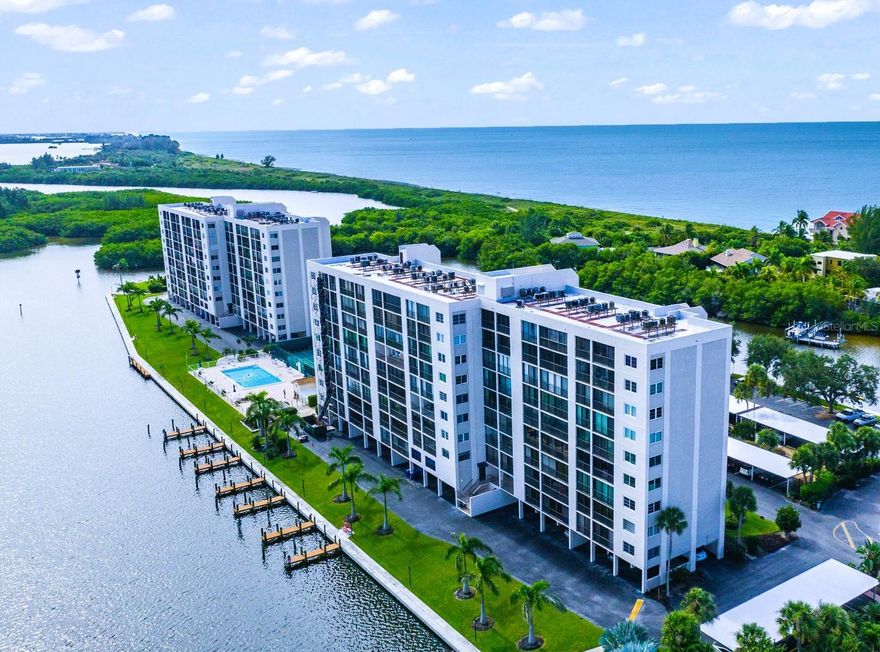 Live your dream in this light and bright 6th-floor 2-bedroom, 2-bath condo with spectacular views of both the Gulf and the Bay! This unit is the perfect place to watch a sunrise or a sunset and soak in the beauty of Neville Preserve, Little Sarasota Bay, and the Gulf!  Gorgeous bay views are showcased along the back of the unit through floor-to-ceiling sliders that span the entire space.  The open kitchen features quartz countertops, white cabinetry, stainless steel appliances, and full Gulf views. The large master bedroom overlooks the Bay and features abundant closet space and an en-suite bath.  A second bedroom and hall bath are ideal for family and/or guests.  Additional conveniences include a washer/dryer in a closeted utility area and a ground level storage unit—perfect for beach and golf gear.  An assigned covered parking space is conveniently located near the building entrance. Furnished and move-in ready!.  The Pointe, a unique community located at the southernmost end of Siesta Key, is surrounded by water on three sides. Just south of The Pointe, recently reopened Midnight Pass connects the Bay and Intracoastal Waterway to the Gulf - enhancing boating, estuaries, marine life, and real estate values!  A gated property, The Pointe is beautifully landscaped and features every amenity: a heated pool and spa, lighted tennis and pickle ball courts, private boat docks, kayak and paddleboard racks and launch, exercise rooms, men's and women's saunas, a beautiful club house with a fireplace and a full kitchen, a private island with gazebo and grills, and on site management and maintenance. This five plus acre property is conveniently located just a few minute's walk from Turtle Beach and three restaurants. Come live at the less traveled, more tranquil end of the Key and enjoy the walking and bike paths under tree-lined Midnight Pass Road. Boat docks are available!!