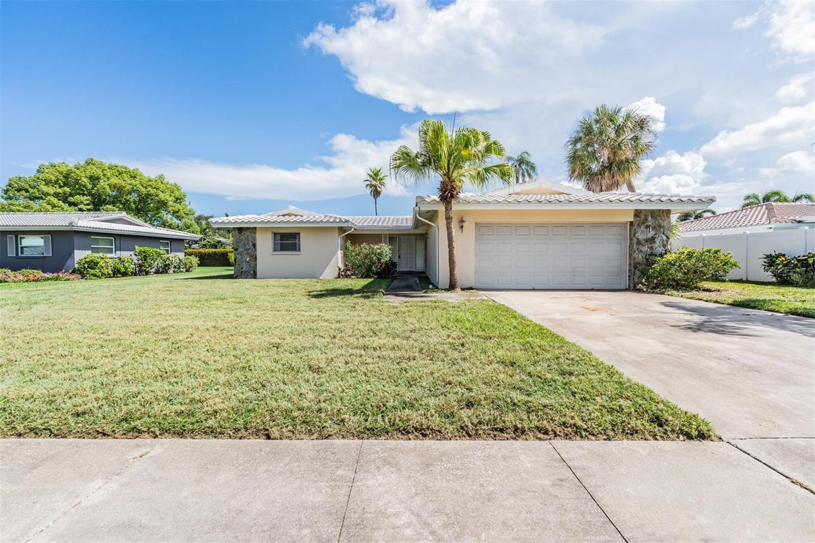 Roomy 2-Bedroom Home in a Great Neighborhood – Just Minutes from the Gulf! This diamond in the rough is tucked into a charming, well maintained neighborhood. A generously sized 2-bedroom, 2-bath home that is full of potential. With all original features, it's the perfect canvas for your personal touch or a savvy renovation. The floorplan includes a spacious living area, separate dining space and an open kitchen. There's a large backyard with room to grow-perfect for outdoor fun or future projects. Just a short drive to award-winning Gulf beaches (approx. 2 miles), shopping and dining all nearby too. Whether you're an investor, first-time buyer, or looking for a winter retreat, this is an opportunity to own in a fantastic area at an approachable price. The Tile Roof was Replaced in 2020 and Newer AC in 2023! This IS NOT In A Flood Zone. Put this one at the top of your must see list!