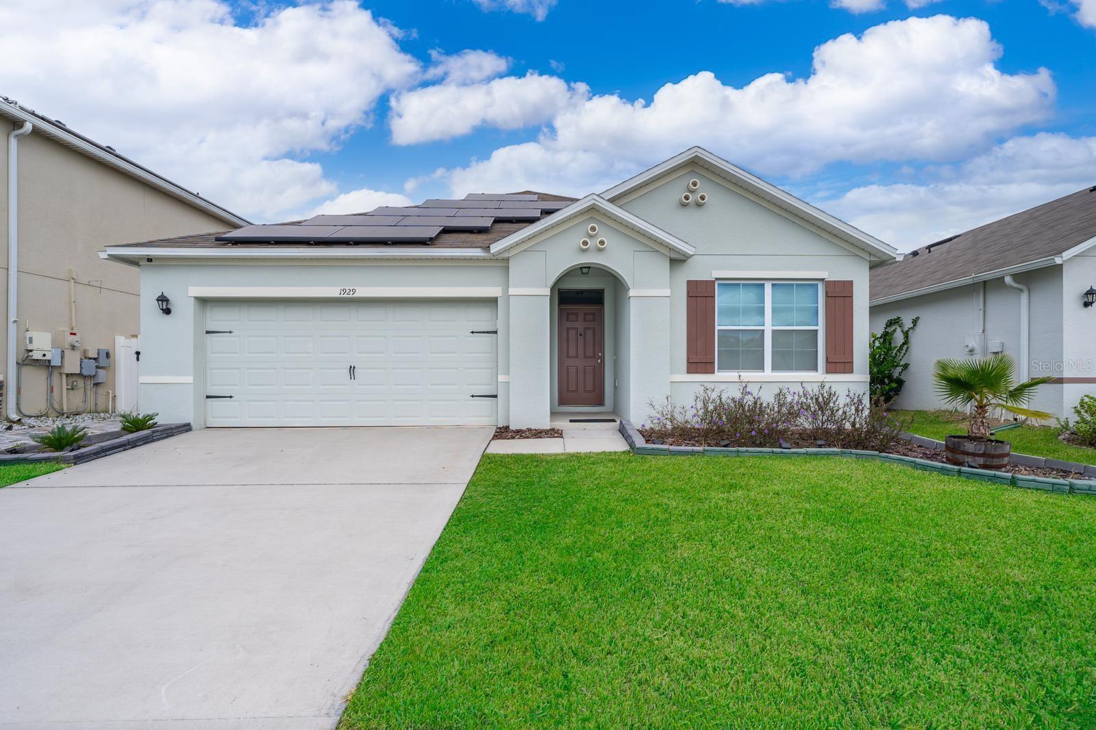 Welcome home to the desirable Kindred community. This beautiful 3-bedroom, 2-bathroom home features an open-concept kitchen and living room overlooking the family room, dining room, and covered lanai with a motorized screen. This exquisite home boasts plenty of space for perfect family gatherings. This incredible home boasts over 2,260 square feet in total, including covered patios and outdoor living space. Included Features: 42" cabinets and island in kitchen, ceramic tile in all wet areas, stainless steel appliances included. The master bedroom, located at the back of the home for privacy, has an ensuite bathroom that features a double sink with a shower and a large walk-in closet. Two additional bedrooms share a second bathroom. This home also features a nice laundry space with a privacy door and a pantry in the kitchen. Solar panels at no additional cost that will drastically improve your electric bill. The garage comes prepped with hookups for your electric vehicle. No rear neighbors and a premium lot with conservation area. Conveniently located near the Turnpike and Orlando International Airport, you will feel like you have left the city while in reality being just minutes from fine dining, amazing shopping, and all of Central Florida's amazing theme parks.