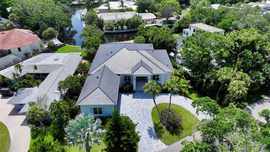 Just Completed! This brand-new, custom waterfront home on Siesta Key is now move-in ready, built above current elevation code with a brand-new raised seawall and dock, offering an unparalleled display of high-end, designer finishes throughout. The home features a spacious, open-floor plan with 5 bedrooms, 4 full bathrooms, and a sizable chef's kitchen complete with custom-designed cabinetry, an oversized cooking island, panel-ready Thermador appliances, and under-cabinet lighting. A custom wine bar with a dual-temperature wine fridge adds to the kitchen’s appeal, while the large dining area provides stunning water views. Every inch of this home reflects meticulous attention to detail, including engineered hardwood floors throughout, solid core 8' interior doors, and high-impact windows and doors. The living room and primary bedroom boast 12-foot ceilings with tongue & groove and custom beam accents and expansive glass sliders leading out to the pool patio, providing seamless indoor-outdoor living. The external living space is enhanced by an elevated pool patio, a heated saltwater pool and spa, a shallow sun shelf, and a full outdoor kitchen—all with panoramic canal views, perfect for embracing the Florida lifestyle. The home is equipped with the latest technology and conveniences, including Cat 6 wiring at all TV locations, pre-wiring for security cameras, and a built-in indoor/outdoor speaker system. Located in the heart of Siesta Key, this home is within walking or biking distance to the famous white sand beaches and the vibrant shopping and dining district of "The Village." Don’t miss this opportunity to own this exquisite new construction—contact us today for more information!