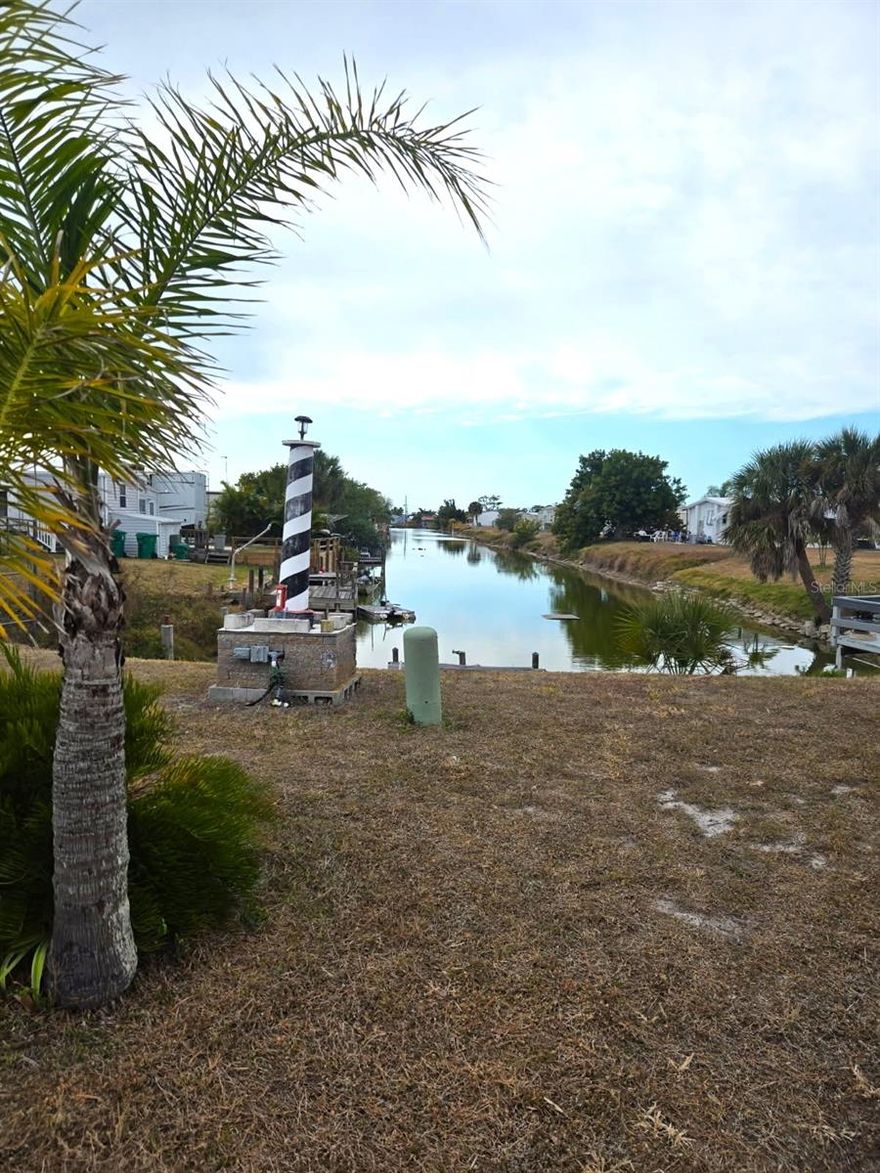 Amazing opportunity to own this truly affordable WATERFRONT home on a freshwater canal in this 55+ community where the HOA fees are a mere $315 annually.  Featuring a split bedroom floor plan with 2 bedrooms and 2 baths, this turnkey home is perfect for entertaining or relaxing in the glassed in lanai.  Watch gorgeous sunsets from your dock with a long water view down to the tranquil Redfish Canal. There is abundant natural wildlife in the area, backyard fishing and a unique waterway ideal for kayaks, paddleboards, canoes as well as shallow boats.  Meticulously maintained, this home can be your new retirement residence or your winter getaway.  The Holiday Mobile Estates community nestled in Englewood offers many Clubhouse amenities including the heated pool overlooking the lake, tennis courts, pickleball, shuffleboard and more.  This very special location is close to great shopping, restaurants from casual to gourmet and world class Golf Courses.  Enjoy the relaxed atmosphere of artsy & quaint Olde Englewood Village, Sarasota cultural activities such as the Mote Marine Laboratory & Aquarium, the Ringling Museum, Sarasota nightlife and much, much more.  Plus this location is just a 15 minute drive to Englewood Beach.
