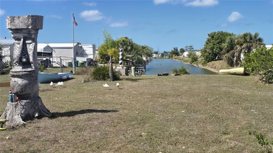 Amazing opportunity to own this truly affordable WATERFRONT home on a freshwater canal in this 55+ community where the HOA fees are a mere $315 annually.  Featuring a split bedroom floor plan with 2 bedrooms and 2 baths, this turnkey home is perfect for entertaining or relaxing in the glassed in lanai.  Watch gorgeous sunsets from your dock with a long water view down to the tranquil Redfish Canal. There is abundant natural wildlife in the area, backyard fishing and a unique waterway ideal for kayaks, paddleboards, canoes as well as shallow boats.  Meticulously maintained, this home can be your new retirement residence or your winter getaway.  The Holiday Mobile Estates community nestled in Englewood offers many Clubhouse amenities including the heated pool overlooking the lake, tennis courts, pickleball, shuffleboard and more.  This very special location is close to great shopping, restaurants from casual to gourmet and world class Golf Courses.  Enjoy the relaxed atmosphere of artsy & quaint Olde Englewood Village, Sarasota cultural activities such as the Mote Marine Laboratory & Aquarium, the Ringling Museum, Sarasota nightlife and much, much more.  Plus this location is just a 15 minute drive to Englewood Beach.