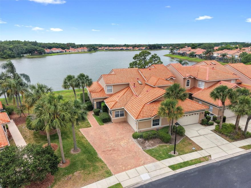 Experience a more refined side of Florida living in this beautifully updated waterfront end-unit townhome, tucked inside the gated, Waterview community in the Shingle Creek area. Thoughtfully updated, the home features new kitchen cabinetry and bath vanities, brand-new appliances, updated lighting throughout, and freshly painted.  The main level has an open living area where a spacious living room overlooks the patio and tranquil water views, creating a relaxed, everyday backdrop. A wet bar adds convenience for entertaining. The dining room is perfectly set up for entertaining while the eat-in kitchen is great for day to day meals. The kitchen is complete with marble countertops and backsplash, pantry, and a gas range. The primary suite is privately situated on the first floor, offering direct patio access, a generous walk-in closet, and a well-appointed bath with dual sinks, new vanity, a separate shower, and a jetted tub. Upstairs, two generously sized bedrooms share a full bathroom, and a private balcony provides an additional outdoor retreat. The A/C was replaced in 2023. Residents of Waterview enjoy a secure, low-maintenance lifestyle with gated access, security cameras, and included services such as lawn care, roof cleaning, cable, and monitored security. Community amenities include a resort-style pool and tennis courts. Ideally located just minutes from SeaWorld and Dr. Phillips with easy access to Orlando International Airport and major highways. World-class attractions, dining, and shopping—including Walt Disney World, Universal Orlando, and ICON Park are all within close reach, offering a balance of everyday convenience and quiet retreat. A thoughtfully updated home in a well-kept community that is worth experiencing in person. Schedule your showing today.