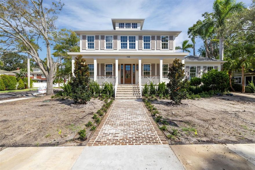 Under Construction. Est. Completion: December 2025 | This is a CANOPY SIGNATURE HOME in collaboration with LAUREN LEITNER DESIGN. Would you love to live just steps from BEACH DRIVE in St. Petersburg’s coveted Historic Old Northeast in a custom designed Canopy Home? Here’s your chance to make that dream a reality with Canopy Builders – St. Petersburg’s most trusted name in luxury home construction. This new build sits on a desirable 89 x 110 sq ft corner lot and offers 4 Bedrooms + Study + Loft, 4 Baths, an oversized 2-car garage, pool and spa, plus an Accessory Dwelling Unit (ADU) with 1 bedroom and 1 bath. The main residence boasts 3,985 sq ft of living space, with the ADU adding 589 sq ft for a total of 4,574 sq ft under air. The ADU includes a full kitchen, laundry, and walk-in closet—ideal for guests, extended family, or rental income. Surrounded by brick streets and mature oak trees, this home blends modern luxury with timeless character, just a 10-minute walk to downtown St. Pete and the waterfront parks. From the welcoming front porch, you enter a foyer with tongue-and-groove paneling and designer lighting, while the formal dining room showcases grasscloth wallpaper, wainscoting, and a statement chandelier. The great room boasts a fireplace and coffered ceilings, flowing seamlessly into the kitchen, designed as both a chef’s dream and a gathering space. The kitchen features a La Cornue range, paneled Sub-Zero refrigerator, Bosch dishwasher, and inset custom cabinetry, anchored by a white oak island with Calcutta marble countertops, tongue-and-groove ceiling, and a custom reeded range hood. A breakfast nook with a gold pendant sits just beyond, while the butler’s pantry impresses with a paneled Avalon wine cooler, deep green cabinetry, brass shelving, marble counters, and gold hardware. The main level also includes a mudroom with dark cabinetry and brick herringbone flooring, a powder room with wallpaper and a soapstone vanity, and a laundry with custom cabinetry, marble checkerboard floors, and Calcutta counters. The primary suite offers wood-beamed ceilings and a spa-like bath with gold accents, fluted vanities, and Calcutta marble. Upstairs, a loft opens to three bedrooms, each with its own en suite, including designs with navy handcrafted tile and dark wood vanity, gingham tile with marble accents, and a white reeded vanity with silver hardware. The upstairs laundry includes deep green tile, Carrera marble counters, and soft white cabinetry. Canopy not only designed the interior but also customized all exterior finishes. Out back, enjoy a custom pool and spa, outdoor kitchen with grill and brick hood, and lush surroundings. The detached ADU includes quartz counters, white cabinetry, and subway tile backsplash. Planned features include Hardie Board siding, a tankless gas water heater, impact-resistant windows, and engineered hardwood floors throughout. Dual digital thermostats allow independent climate control. Additional luxuries include 10’ ceilings on the first floor, 9’ ceilings on the second, 8’ interior doors, and Canopy’s signature gas sconces on the porch. This home is walking distance to waterfront North Shore Park, biking distance to downtown, and just a 20-minute drive to St. Pete Beach or Tampa. Contact us to learn more about the custom finishes that make this home truly one of a kind.