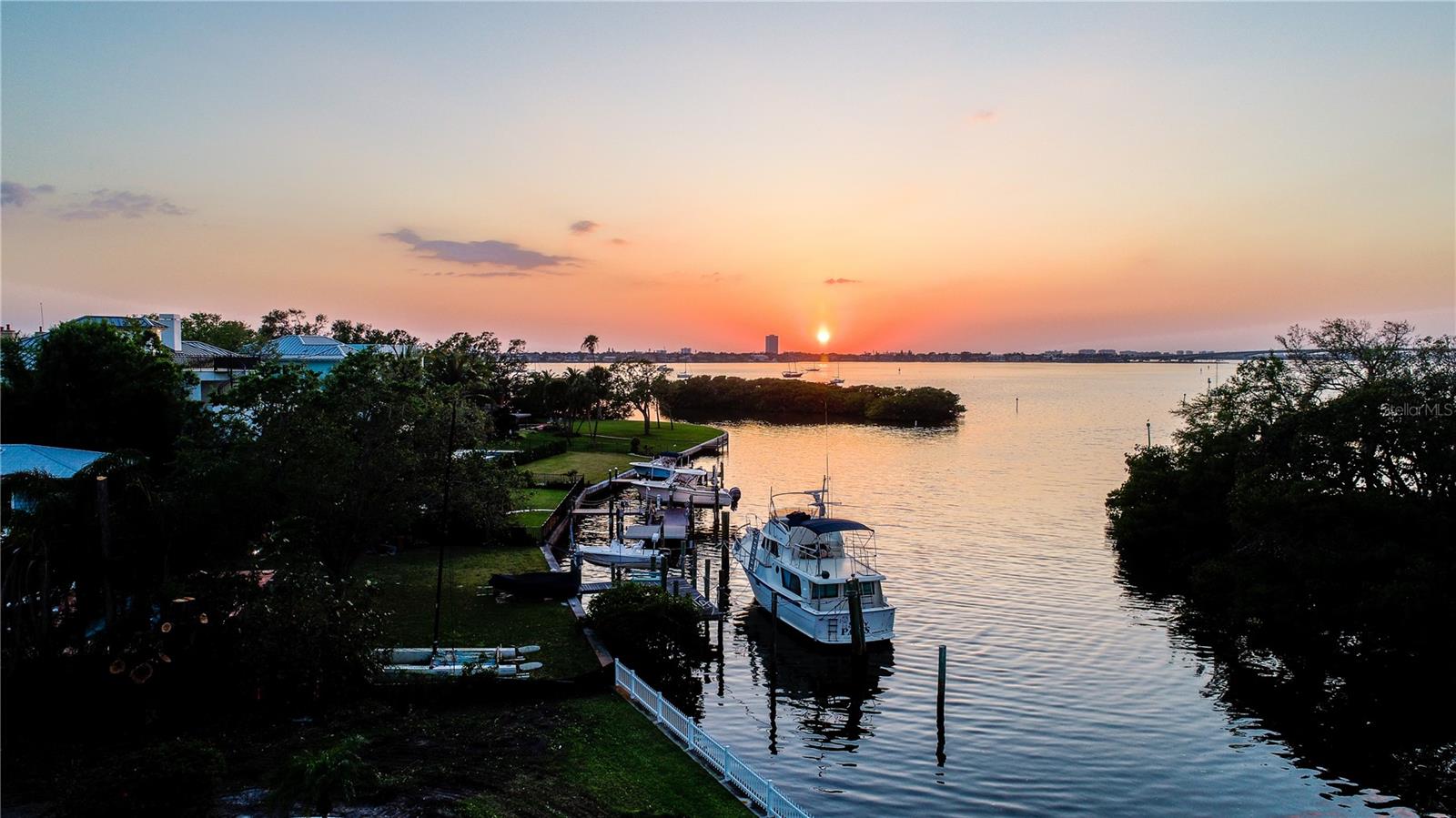Located in the sought-after Bay Point Park neighborhood, this 20,389± SF waterfront lot offers the opportunity to build a custom residence in a premier West of Trail setting. With 90 feet of frontage on deep, protected water where Hudson Bayou meets Sarasota Bay, the property provides direct boating access and captures panoramic views of Selby Gardens, the city skyline, the Ringling Bridge and open bay waters.
Recent site improvements include a newly constructed seawall and an engineered drainage system designed to channel rainwater directly into Hudson Bayou, helping maintain a dry, well-maintained property. These enhancements add long-term stability and readiness for development.
This prime location is just minutes from Downtown Sarasota, Southside Village, St. Armand's Circle, and the area’s renowned Gulf beaches. The property is offered with a build contract through Dynan Construction, providing two sets of building plans that can be used as-is or customized. Buyers also have the flexibility to work with their own architect or collaborate with Dynan’s design team to create a fully tailored residence. Based in Sarasota, Dynan Construction is known for delivering distinctive, turnkey homes and has completed numerous luxury properties in the immediate area, overseeing every stage from site preparation to final delivery.