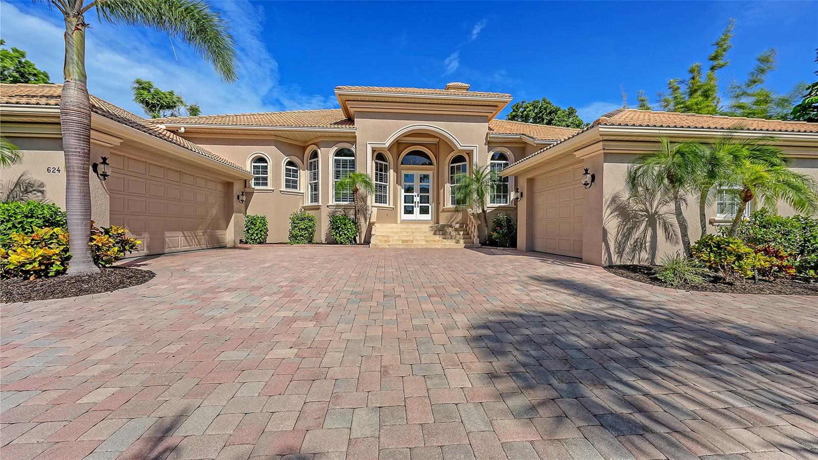 From the moment you enter through the stunning new double-entry glass doors, this custom-built waterfront residence welcomes you with a refined sense of comfort and coastal luxury. Located in the exclusive island community of Bird Key, one of Sarasota’s most sought-after neighborhoods, this exquisite four-bedroom, three full and two half-bath home blends timeless architectural elegance with vibrant tropical charm. Spanning over 3850 square feet of beautifully appointed living space. The home was built in 2003 and elevated to over 12 feet, making it one of the newer and more resilient properties on the island. Impeccably maintained and thoughtfully enhanced over time, it showcases quality craftsmanship, open living areas, voluminous tray ceilings, and seamless indoor-outdoor flow throughout.
The main-level living boasts a versatile layout with all four bedrooms and the spacious office/den located on the main level, providing ease and functionality for everyday living. The interiors are light-filled and inviting, with a formal dining room, separate living and family rooms, and a recently renovated kitchen with casual dining—all offering beautiful views of the canal and pool. A versatile bonus room upstairs—complete with a half bath, wet bar, and access to a spacious balcony—offers incredible flexibility as a media room, gym, guest space, or secondary office. From here, enjoy stunning sunset views over the water, making it the perfect spot to unwind.
Step outside to a tropical backyard oasis, where lush landscaping, a sparkling pool and spa, and a three-tiered terrace create the feel of a private resort. The newly installed louvered pergola—equipped with electric fans and rain sensors—enhances comfort and allows for year-round enjoyment. Expansive covered patios and multiple seating areas provide ideal settings for both entertaining and relaxing.
Situated on direct sailboat water with no fixed bridges, the property offers easy and immediate access to Sarasota Bay and the Gulf of Mexico. The private dock includes two boat lifts, a floating dock for kayaks and paddleboards, and 13 feet of water depth—perfect for larger vessels. A newly constructed seawall with Julio beam reinforcement by Steeler Foundation ensures long-term durability and peace of mind.
This property offers two separate air-conditioned garages, providing both functionality and flexibility for your lifestyle. The main two-car garage delivers ample space for everyday vehicles, while the second garage—perfect for a third car—doubles as a versatile space for all your toys, from golf carts and bikes to paddleboards and tools. Both garages are climate-controlled, ensuring comfort and protection year-round, whether you're storing prized possessions, working on a hobby, or simply seeking additional organized storage. A rare feature that adds tremendous value and convenience to this exceptional home.
Bird Key residents enjoy an enviable island lifestyle, with world-class shopping and dining at St. Armands Circle to the west and the vibrant cultural scene of downtown Sarasota to the east. Membership to the Bird Key yacht club is optional for additional fee.