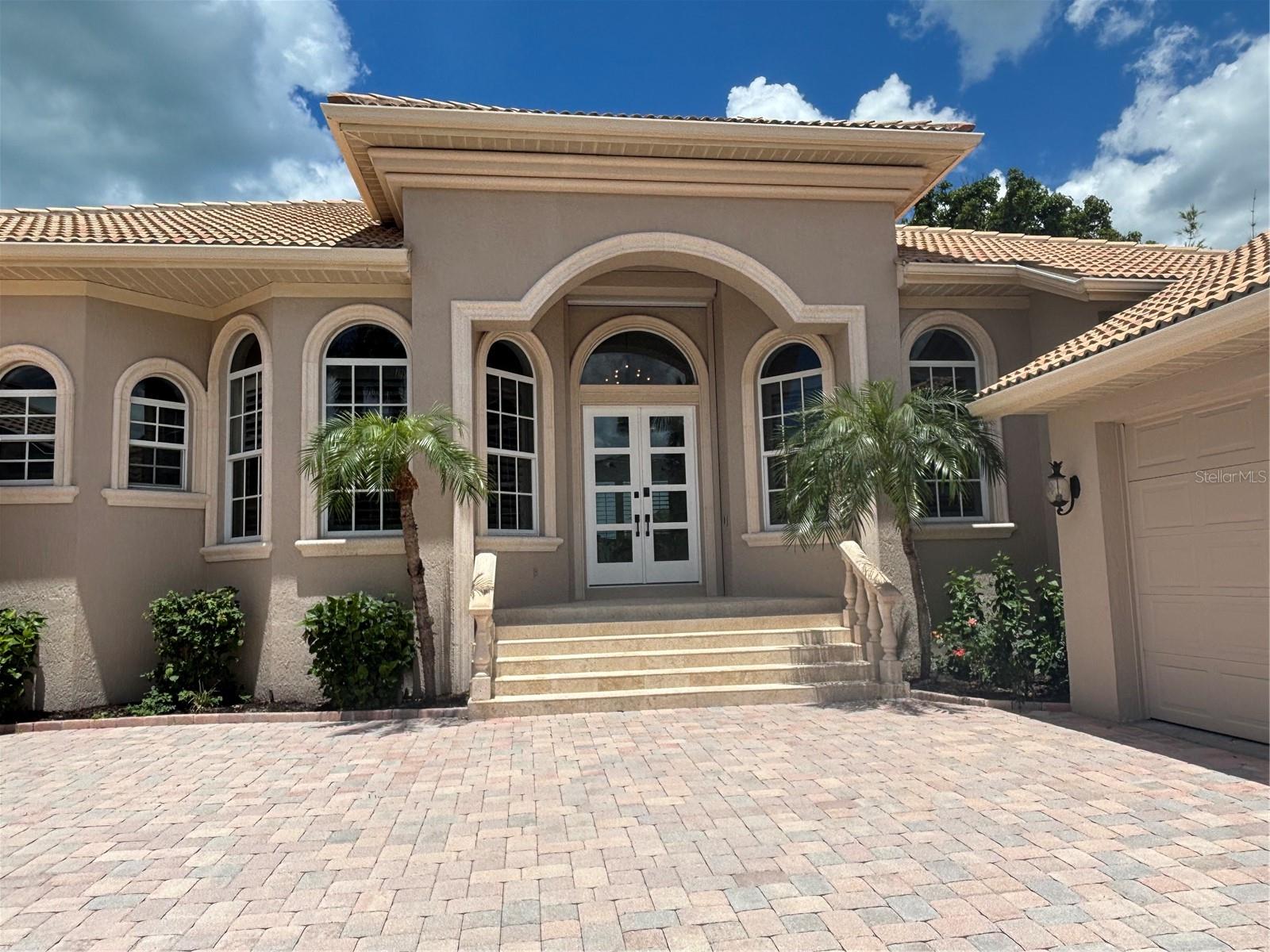 (Professional Photos Coming).From the moment you step through the stunning new double entry glass front doors of this Custom-built masterpiece, you’ll immediately feel at home. Combining the timeless elegance of Bird Key waterfront living with vibrant tropical accents, this impeccably designed residence is a true gem. All four spacious bedrooms are located on the main level, along with a generously sized den/office, offering both comfort and convenience. Situated on direct sailboat water with no bridges, this home features two boat lifts, providing you with the perfect opportunity to own a boat of your choice—enabling smooth sailing right from your backyard. Built in 2003 with a 12' elevation, this home stands as one of Bird Key’s newer properties, and its exceptional condition is a true testament to quality craftsmanship.
The bright and airy living spaces include a formal dining room, living and family rooms with breathtaking water views, and a charming recently renovated kitchen with a casual dining overlooking the pool and canal. Upstairs, a versatile bonus room with a half bath opens to a spacious balcony, perfect for enjoying stunning sunset views. The main-level master suite serves as a true retreat, featuring expansive walk-in closets and an elegant master bath.
Step outside to your lushly landscaped, three-tiered waterfront terrace, complete with a graceful pergola and a sparkling pool. The impressive private dock, equipped with two boat lifts and a floating dock for kayaks and water toys, allows for immediate water access—ideal for boating enthusiasts.
This home boasts luxurious finishes throughout, including 24" marble tile inside and 18" tumbled marble outside on the three-level patio. The canal features 13 feet of water depth, perfect for docking. Additional upgrades include a paver driveway, new flooring in all bedrooms and the bonus room, insulated garage doors with newly coated and sealed flooring. The owners have also replaced the seawall, reinforced with Julio beams by Steeler Foundation, and added new stairs to the dock. New and updated pool equipment, new glass entry door, new insulation throughout the attic, sealed can lights, new air conditioners with humidifier, and plantation shutters on every window
Expansive outdoor patio space with multiple seating areas and a brand-new louvre porch with electric, fans and rain sensors.
Garage mini-splits for additional climate control and extra storage space.
With over 3,300 sq ft of living space, including 4 bedrooms plus office, 3 full baths, and 2 half baths, this home is spacious and beautifully designed. The layout flows seamlessly, and the outdoor spaces feel like an extension of the home, offering abundant room for both relaxation and entertaining. Bird Key residents enjoy an enviable island lifestyle, with world-class shopping and dining at St. Armands Circle to the west and the vibrant cultural scene of downtown Sarasota to the east. Membership to the Bird Key yacht club is optional for additional fee.