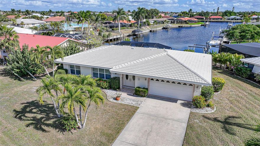 Welcome to your slice of the Florida waterfront lifestyle at 920 Juno Drive, perfectly positioned on a saltwater canal in the heart of desirable Punta Gorda Isles. This 3-bedroom, 2-bath home with a 2-car garage offers the kind of setting that makes everyday life feel like a getaway.
Step outside and you’ll immediately see where this property truly shines. The beautiful pool area is framed by mature landscaping and tranquil canal views, creating an ideal space for relaxing afternoons, weekend gatherings, or evening swims under the stars. Whether you’re entertaining guests or enjoying quiet mornings poolside, the outdoor living space is the centerpiece of the home.
For boating enthusiasts, the private dock on a saltwater canal provides direct water access, making it easy to enjoy spontaneous boat rides, fishing, or sunset cruises through the Punta Gorda Isles canal system and out to Charlotte Harbor. This is the lifestyle many seek — waterfront living with the convenience of being minutes from open water.
Inside, the home offers a functional layout with three bedrooms and two bathrooms, providing a solid foundation and the opportunity to update and personalize to your taste. The interior allows the next owner to reimagine the space while already enjoying the unbeatable location and outdoor amenities.
Located in a well-established, waterfront neighborhood, this home is just minutes from downtown Punta Gorda, Fishermen’s Village, parks, dining, shopping, and waterfront events. Punta Gorda Isles is known for its boating culture, walkability, and relaxed coastal atmosphere, making it a highly sought-after place to call home.
Whether you’re looking for a full-time residence, seasonal retreat, or investment opportunity, 920 Juno Drive offers the rare combination of prime canal frontage, a gorgeous pool setting, and an exceptional location — all waiting for your vision to bring it to life.