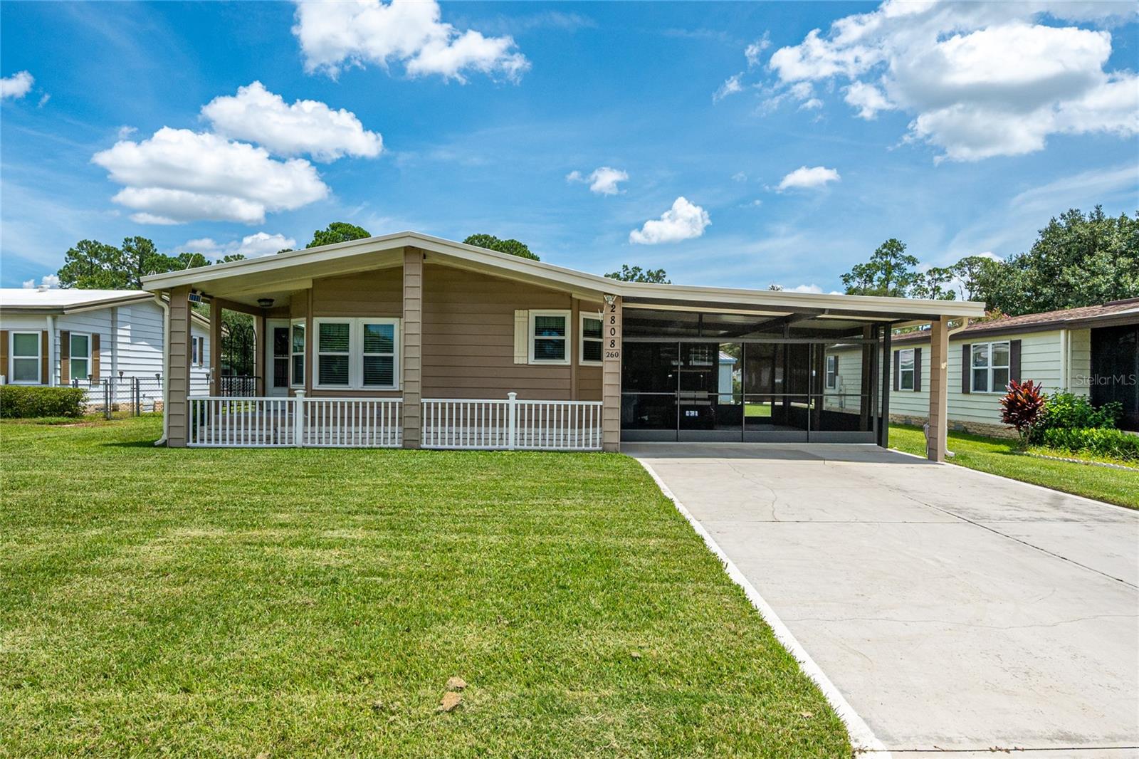 Live the Lake Life at Fox Run!
Welcome to Fox Run, a vibrant 55+ community in Tavares — just a stone’s throw from downtown and only 15 minutes to charming Mount Dora. As you arrive, you’ll notice the double driveway and screened-in carport, offering plenty of parking options or the perfect setup for a driveway party. A quaint front porch and spacious enclosed lanai provide both outdoor and indoor areas to relax or entertain.
Inside, this open-concept home flows effortlessly from room to room, making entertaining a breeze. You’ll appreciate the generous storage options, including multiple closets and a built-in desk with cabinetry in the laundry room. The large bedrooms and ample closet space ensure both you and your guests feel comfortable and pampered. Outside you'll find solar flood lights, an antenna that offers 60 channels, a sidewalk from the driveway to a sizable storage shed — ideal for tools, crafts, or your very own hobby shop. Your house, your choice. Make it yours today!
