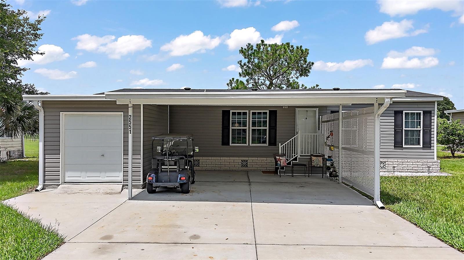 3 BED/2 BATH HOME BUILT in 2019 OVERLOOKING GOLF COURSE in GATED 55+ COMMUNITY!. Start your mornings with stunning fairway views and end your day enjoying peaceful sunsets from the comfort of your own home. Designed with comfort and convenience in mind, this home features a spacious and split floor plan. Primary bedroom off of the living room features WALK-IN closet, en suite bathroom with double sink vanity, tub/shower combo and door that leads into the inside laundry room. The kitchen includes modern appliances, ample cabinetry, closet pantry and a beautiful view of the backyard/golf course. Off of the kitchen you will find the dining room that features sliding doors out to the screened-in lanai with amazing views of the 18th tee box and fairway. Both guest bedrooms have built-in closets and guest bathroom featuring tub/shower combo. You’ll love the LARGE carport and dedicated golf cart garage, giving you plenty of room for parking and storage. Zellwood Station is one of Central Florida’s most desirable 55+ golf course communities, known for its friendly atmosphere, well-maintained grounds, and resort-style amenities. This resident-owned, gated community offers an active and affordable lifestyle with something for everyone. Residents enjoy access to multiple swimming pools, a hot tub, pickleball and tennis courts, shuffleboard, a community restaurant (“The Whistle Stop”), a full calendar of social events and clubs, and a 72-par championship golf course with resident memberships available. For added convenience, RV and boat storage is available on-site. The monthly HOA fee includes cable TV, high-speed internet, sewer, trash pickup, and 24-hour staffed gate access—giving you peace of mind and low-maintenance living. Located just down the road from 429 connect for easy access to medical facilities, airport, Orlando, and easy commute to Downtown Mount Dora. Schedule your private tour today and discover the lifestyle waiting for you at Zellwood Station!