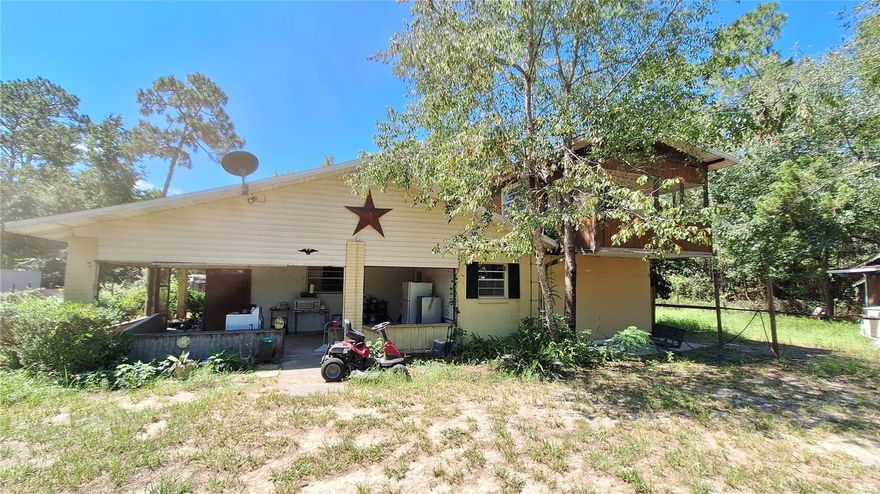 The main home is a 3 bedroom 2 bath with inside laundry, dining area, living room, front porch, back porch, 2 car carport and 2 storage buildings. The master bedroom and bath are upstairs with a balcony. The second home is a single wide mobile home 2 bedroom 1 bath with 2 porches. A total of 1.79 acres zoned Agricultural. The land adjoins thousands of acres of Ocala National Forest located on the east side of the property. The mobile home has a tenant. The main house needs some work.