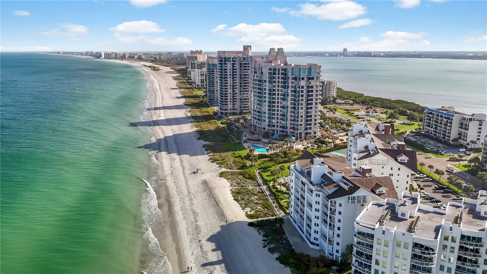 Experience refined coastal living at its finest in this impeccably renovated condominium on Sand Key Beach. With over 1,700 square feet of thoughtfully designed interior space, this 3-bedroom, 3-bath residence—plus a versatile bonus room—showcases expansive water views and a seamless blend of comfort and sophistication. Completely updated in 2021, the open-concept living and kitchen areas capture sweeping vistas of the Gulf, setting the stage for everyday elegance. The chef’s kitchen is outfitted with rich quartz stone countertops, custom soft-close cabinetry, and high-end finishes that make entertaining effortless. The living area is anchored by a striking wood burning fireplace, framed by an artfully designed stone accent wall that adds texture, warmth, and visual sophistication to the space—creating a stunning focal point for both relaxing evenings and upscale gatherings. The luxurious primary suite is a serene retreat, offering spectacular water views, a custom walk-in closet with dedicated shoe storage, and a spa-inspired en-suite bath. Guests will enjoy privacy in the secondary bedroom, also featuring its own en-suite, while the third bedroom overlooks the peaceful inland waterway. A flexible bonus room provides the ideal setting for a home office, media lounge, or creative studio. Step onto your private balcony to take in breathtaking sunsets over the Gulf. Storage is abundant with three designated closets—on the balcony, in the hallway, and in the garage—for all your beach and lifestyle essentials. A covered parking space adjacent to the elevator offers added convenience. Residents of the Cabana Club enjoy an array of upscale amenities including direct beach access, a geothermal heated pool, fitness center, and basketball and pickleball courts. This unit stands out with premium upgrades such as raised ceilings, a whole-house surge protector, hurricane-impact sliding doors, storm shutters, Coastline Vinyl plank flooring for durability in coastal conditions, updated HVAC & water heater. Situated on prestigious Sand Key, this residence offers the perfect balance of tranquility and accessibility. Just south of iconic Clearwater Beach, Sand Key is known for its peaceful shoreline, upscale ambiance, and relaxed coastal charm. Travel is effortless with both Tampa International and St. Pete–Clearwater airports within easy reach. Fine dining, boutique shopping, and cultural attractions in Tampa, St. Petersburg, and beyond are just a short drive away—delivering the ideal blend of serene beachfront living and vibrant city access. With only four residences per floor in Building 1586, privacy and exclusivity are paramount. Milestone inspection is complete and passed; no Phase 2 required. This turnkey beachside residence is ready to be yours—schedule your private showing today.