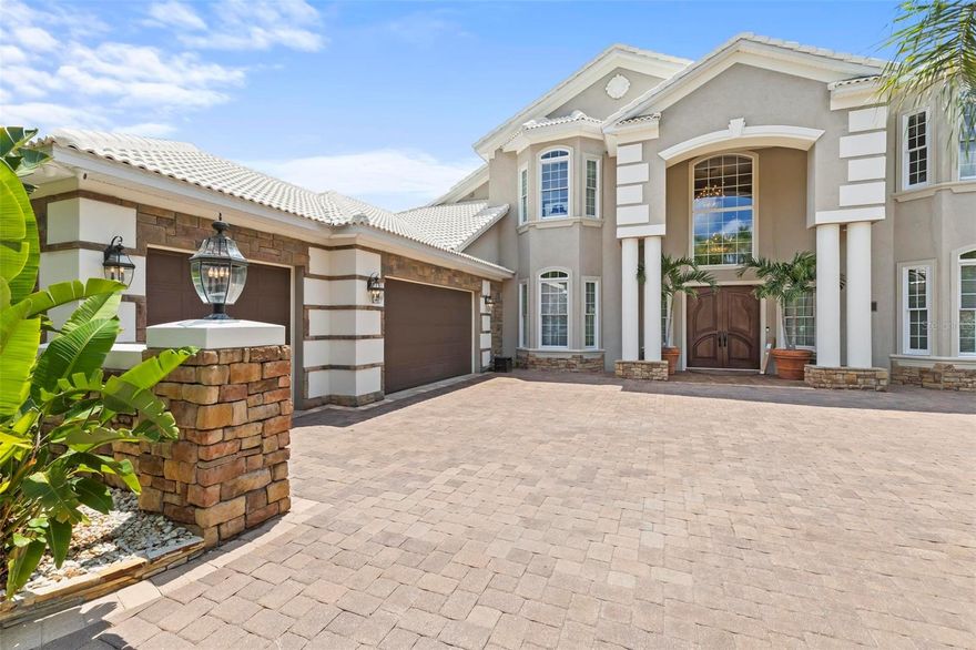 Boaters Dream!! Don’t Miss This Luxurious Waterfront Retreat on a Wide Canal in Palm Coast Florida. Nestled within the serene enclave of The Sanctuary at Palm Coast, this opulent residence offers unparalleled luxury living. Step through the grand entrance framed by 9-foot solid mahogany French Doors into a world of elegance and sophistication.  With meticulous attention to detail, this home boasts exquisite features including a free-form custom spiral staircase, 11-foot ceilings, transom windows and beautiful millwork. The gourmet kitchen is a chef’s delight featuring custom cabinets, 8-foot island with double stacked granite counters, Viking appliances and a pasta pot filler.  The primary suite, located on the first floor, offers the owners a private retreat with a spacious sitting area, custom-built walk-in closets and a luxurious en-suite bath, complete with a double jacuzzi tub and walk-in shower. Additional interior highlights include a billiard room, home theater, electric fireplace, and Hunter Douglas silhouette shades. Situated on close to 1/2 an acre, this home includes a 1200 square foot screened lanai with a summer kitchen, perfect for outdoor entertaining. The covered porch is accented with a pine ceiling and Sunbrella shades that enclose the area completely with the push of a remote. Enjoy the Florida sunshine in the 40 ft x 15 ft saltwater pool or unwind in the newly resurfaced jacuzzi.  Boating enthusiasts will appreciate the covered dock with 10,000 lb lift, the separate, covered double jet ski lift.  The waterfront area is capable of accommodating Yacht’s up to 60FT.  Pristinely landscaped grounds feature mature palms and custom outdoor lighting, creating a tranquil oasis.  The property also includes a circular paver driveway, whole house water softener system, 3 AC units, hardwired security system, full irrigation system, 3 car finished garage with top of the line doors, built in workbenches and storage. This exceptional home offers the ultimate in luxury living, combining exquisite design with unrivaled amenities.  Don’t miss your chance to own a slice of a Boater’s paradise in Palm Coast.  Schedule your private tour today.