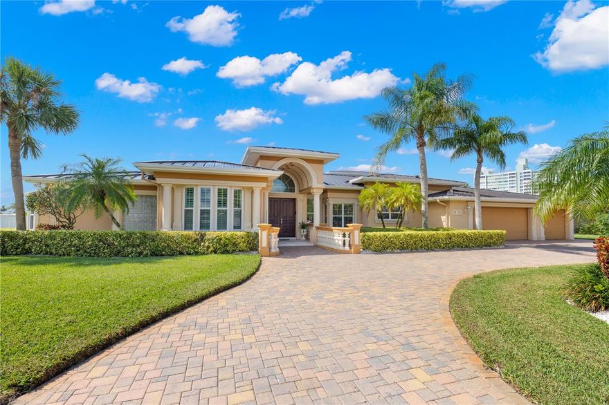 Experience WATERFRONT LIVING at its finest in this stunning Island Estates waterfront move in ready home. Situated on an expansive lot with impressive 179 feet of seawall along a protected DEEP WATER canal & plenty of room for a large boat. 5 bedroom, 3.5-bath, 3-car garage home with over 3700 of living space is a true gem. Recent upgrades are abundant, including a BRAND NEW METAL ROOF in July 2023, for peace of mind a NEW WHOLE HOUSE GENERAC GENERATOR in 2022, NEW SEAWALL in 2018, all 3 HVAC NEW in 2018, all NEW POOL EQUIPMENT in 2019, NEW GAS HOT WATER HEATER 2021, updated impact windows & doors, & custom decorative concrete work performed by hand by European artisans that enhances the exterior's aesthetic appeal. For boating enthusiasts, the large Trex deck is equipped with a 16,000 lb BOAT LIFT and COVERED 2 JET SKI LIFTS, easy access with a short boat ride out to the open waters of the Gulf of Mexico. Step through French doors off the family room to discover the perfect OUTDOOR OASIS. Facing south, it offers unobstructed views down the wide canal. The screened-in SALTWATER GAS HEATED POOL with SPILL-OVER SPA and ample deck space for lounging. An adjacent covered Lanai boasts an ELECTRIC RETRACTABLE AWNING and a COVERED OUTDOOR COOKING AREA with a stainless steel Fire Magic grill, fridge, ice bin and Granite countertops, creating an entertainer's paradise. PUTTING GREEN with artificial turf adds to the outdoor amenities & perfect for honing your golf skills. Curb appeal abounds with a pavered circular driveway, lush landscaping,& thoughtfully placed OUTDOOR LIGHTING. Inside, you'll find a wealth of luxury features, including CERAMIC PLANK TILE FLOORING, crown molding, tray ceilings, plantation shutters, designer lighting, ceiling fans, & CUSTOM WOODWORK throughout. The recently UPDATED KITCHEN is a chef's dream, with white shaker cabinets, a GAS COOKTOP, quartz countertops, a LARGE CENTER ISLAND, & stainless steel appliances, including BUILT IN DOUBLE OVER. It seamlessly connects to the family room, creating a hub for gatherings & entertainment. The main level boasts a large owners retreat with crown molding, wood floors, a wall of windows to enjoy the spectacular views & door that leads to the pool. Ensuite features a FREE-STANDING SOAKING TUB, large walk in shower, dual vanities & lots of natural light. On the Main level you will find 3 guest rooms, a HOME OFFICE with custom maple built in desk and cabinets along with a custom tray ceiling that adds both character & sophistication to this beautiful space, beautiful BAY WINDOW WITH PLANTATION SHUTTERS. Guest bath with STEAM SHOWER has easy access for your guests from both the pool & inside the home. Upstairs, a guest suite with a half bath, wet bar & a separate outdoor entrance serves as a versatile space, sellers currently use it as a GAME/MEDIA ROOM. Island Estates is Tampa Bay's premier residential boating community, offering a host of conveniences such as a new PUBLIX just 5 mins away, top restaurants, UPS store, convenience store, nail salon, gas station, yacht dealer, waterfront playground, WORLD FAMOUS CLEARWATER AQUARIUM & so much more. Plus, it's just a 15-minute walk to the AWARD WINNING CLEARWATER BEACH or you can cycle on the bike trail or take your golf cart! Mins to Morton Plant Hospital & a short 25-30 min drive to major airports. This home epitomizes the Florida waterfront lifestyle; don't miss your chance to make it yours & start living your best life on the water!