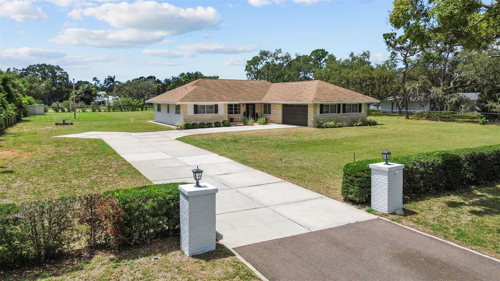 One or more photo(s) has been virtually staged. Welcome to your dream property at 13198 98th Ave, Seminole — a truly rare opportunity: Located in Unincorporated Seminole, this is an elevated 1.15-acre parcel offering privacy, natural light and limitless potential, located just 5 minutes from pristine Gulf beaches, casual and upscale dining, boutique shopping and highly rated schools. The existing residence is a comfortable 4-bedroom, 3-bath home with a practical, family-friendly layout that flows easily from room to room. Large windows and generous ceiling heights allow abundant natural light and create an inviting atmosphere throughout. The home presents a wonderful canvas for cosmetic updates or structural expansion — whether you envision modernizing the interior, adding outdoor living rooms, or reimagining the footprint entirely with a custom build. The lot’s recent clearing provides immediate visibility and access, making any renovation or new construction straightforward. Positioned 65 feet above sea level and located within an X flood zone, this property delivers added peace of mind for buyers concerned about flood risk. Mechanical upgrades completed in 2021 include a new HVAC system and a 200-amp electrical panel, providing modern efficiency and the capacity to support high-demand appliances, pool equipment or expanded living areas. The entire landscape is served by a robust irrigation system fed by a 300-foot well — a valuable feature that keeps landscaping lush without heavy municipal water use and significantly reduces ongoing maintenance effort. Outdoor possibilities are abundant on this expansive lot: create a resort-style backyard with a pool and spa, add a detached guesthouse or studio, build substantial covered entertaining areas, or design sweeping gardens and recreational space. The cleared acreage also offers excellent sight lines for landscaping design and easy placement of driveways, patios and pool decks. Location is a major draw — enjoy quick access to the Gulf Beaches, popular waterfront parks, neighborhood cafes, grocery and specialty stores, and a variety of dining options. Commuters and families will appreciate the convenient proximity to major roadways and well-regarded schools. This is a unique chance to own an elevated, spacious Seminole property with meaningful infrastructure already in place and tremendous upside. Whether you’re seeking a turnkey move-in with cosmetic updates or planning a full custom build, this parcel delivers flexibility, convenience and lifestyle. Schedule your private showing today to explore the possibilities at 13198 98th Ave.