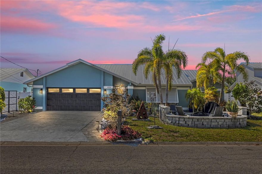 This 4-bedroom, 2-bath home on a canal is truly move-in ready, with direct boating access and your own boat lift, plus a private pool. Every detail has been thoughtfully upgraded.

Improvements include a metal roof (2023), hurricane-proof front door, side panels, garage doors, and bermuda shutters, plus professionally painted walls and an extended lanai with updated screens—perfect for enjoying the Florida lifestyle worry-free. Your outdoor living space is a coastal paradise, featuring a resurfaced pool and deck, new pool heater, outdoor kitchen island, fire pit, decorative fences, and beautiful landscaping.

Inside, the home is equally impressive with a mini-split garage A/C, spacious two-car garage, and all systems maintained in excellent condition. From morning coffee overlooking the canal to sunset evenings by the pool or fire pit, this home blends comfort, style, and functionality at every turn.

Move in, bring your boat, and start living the ultimate Florida waterfront lifestyle!