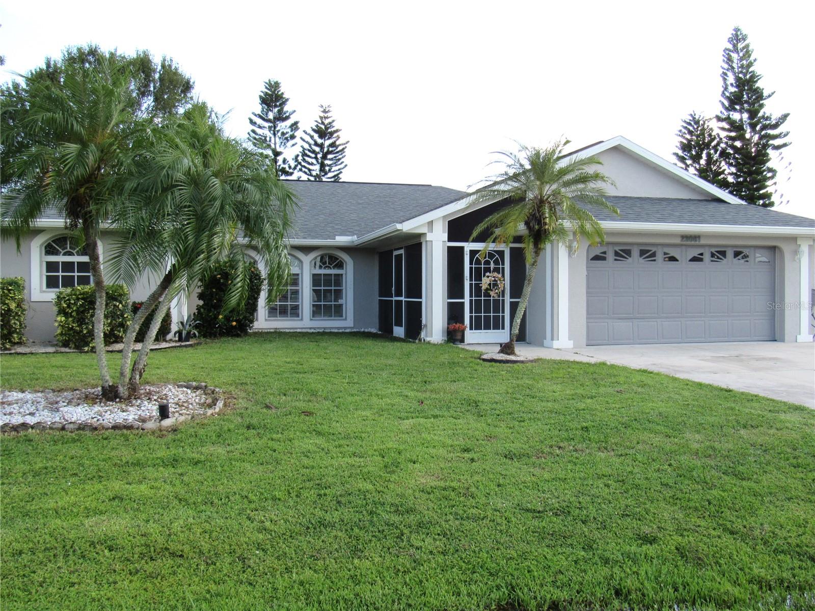 Enter through the screened front porch to this spacious 3 bedroom, 2 bath, 2 car garage POOL home located in the desirable Section 15 in Port Charlotte. There are no HOA fees, located in Flood Zone X and has both public water and sewer. There is no carpeting here. Beautiful luxury vinyl throughout the main living areas, bedrooms and master bath and ceramic tile in the foyer, kitchen and large utility room. The eat in kitchen, open to the family room, features a large breakfast bar, granite counters, tiled backsplash and stainless appliances. There is an abundance of wood cabinetry along with an island for extra work space and storage. You'll have access to the 33 x 10 covered lanai and pool area through triple pocket sliders from the dining room, French Doors from the primary bedroom, single door from the dinette area, sliders from the second bedroom and door from the guest bath for convenience. The ensuite primary bedroom features 2 walk-in closets, large bathroom with double sink vanity with granite top, plus a tiled shower and garden tub. The split plan affords you and your guests, or other family members, plenty of privacy. Enjoy the sparkling pool plus the spacious pool deck with room for chaise lounges and your grill. You even have a fully fenced backyard for privacy. Updates include a New Roof in 2022, whole house re-pipe in 2018, A/C in 2016. Conveniently located just a short distance to I-75, US 41, restaurants, shopping, golf, fishing and more. The beaches on Manasota Key and Boca Grande are just a short drive from your new home. Call to schedule your showing today!