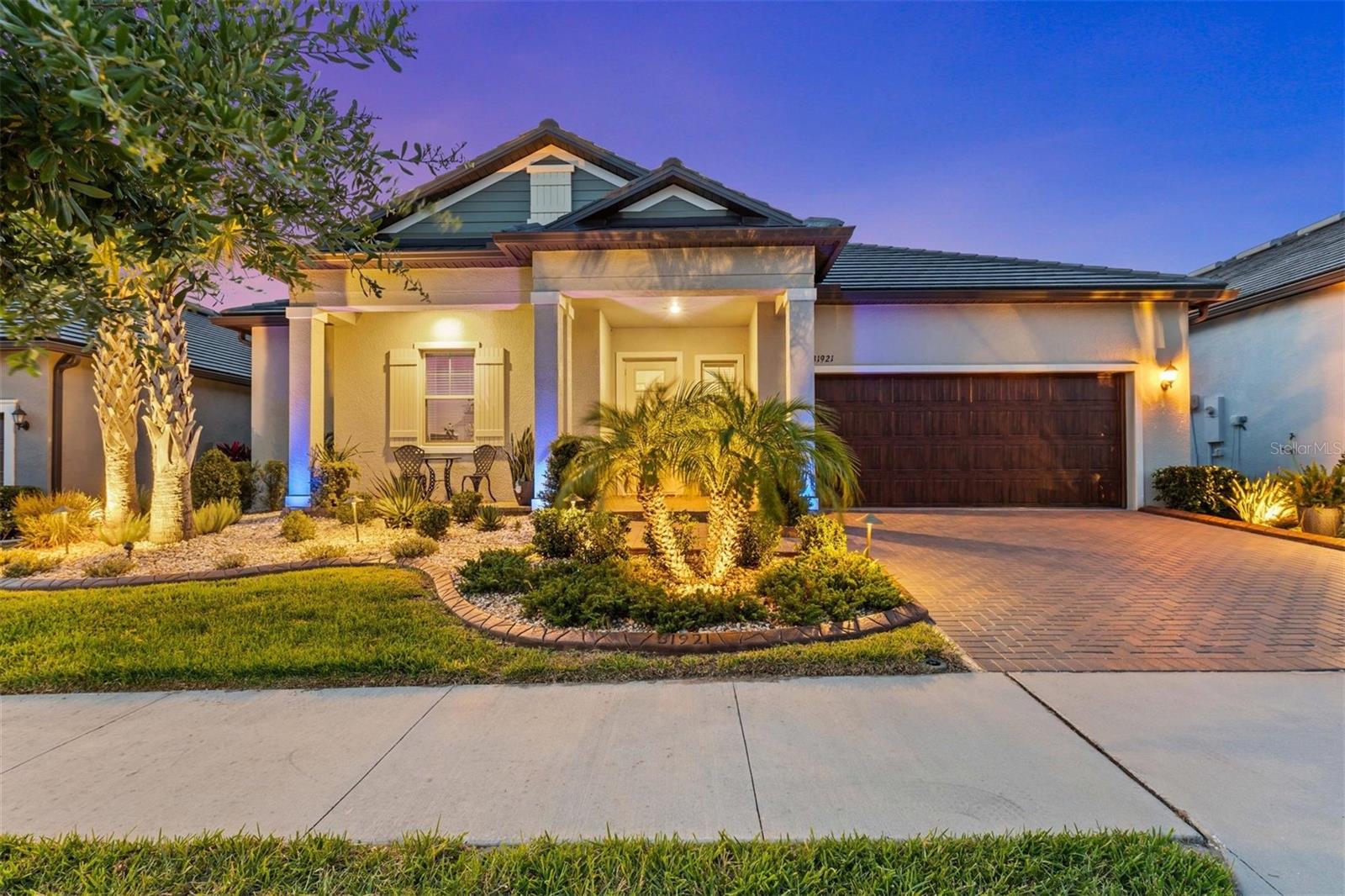 Welcome to this extensively upgraded Argent model in Medley at Mirada, a premier 55+ gated community offering the perfect blend of luxury, comfort, and an active lifestyle. Built in 2022, this 3-bedroom, 2.5-bath home with showcases over $100k in carefully selected enhancements that truly set it apart. From the moment you arrive, you’ll notice the upgraded front elevation with extended patio, premier driveway coating, and lush professional landscaping with brown border, exterior lighting, and a custom rear island. Inside, the open-concept layout is filled with natural light and anchored by upgraded ceramic tile flooring. The kitchen is both stylish and functional, featuring granite countertops, a spacious island with pendant lighting, a butler’s pantry, an oversized walk-in pantry, and a designer backsplash added in 2024. Adjacent living and dining areas flow into the home’s showstopping 600-square-foot screened lanai, expanded concrete slab under new flat roof and finished with epoxy flooring. This outdoor space is ideal for entertaining day & night and features a retractable motorized screen and two remote-controlled awnings with integrated lighting, all completed in 2023. The primary suite is a true retreat, complete with a walk-in shower, dual vanities, and a large walk-in closet fully customized by California Closet. A matching custom vanity with built-in drawers and ceramic tile flooring in the closet elevate the space. The guest bedroom includes its own en-suite bath, while the enclosed flex room with newly installed glass double doors in 2024 makes an ideal home office, 3rd bedroom, creative space, or additional guest area. The home includes a long list of smart and functional upgrades designed to enhance everyday living. A water softener with reverse osmosis was added in 2022, along with a whole-home Alexa system and remote-operated blinds by Tropical Elegance on the triple sliders. The garbage disposal was replaced in 2023, and all ceiling fans and the dining room chandelier were upgraded the same year. Sliding glass doors were replaced under warranty in 2024, with added double screens for improved airflow. Comfort continues with an Ecobee smart thermostat (2025), a whole-home surge protector, upgraded fridge and dishwasher, and a convection microwave oven. The flat roof was upgraded and extended with gutters in 2023 for durability and curb appeal.
Additional thoughtful touches include a 2-car garage with walk-up attic storage—no ladders needed—and a fully coated driveway completed in 2025. Every detail in this home has been chosen to blend form and function with elegance and ease.
Living in Medley means access to unmatched amenities, including a private clubhouse with a resort-style heated pool, poolside bar and café, ballroom, yoga studio, card and billiard rooms, full fitness center, pickleball, tennis, shuffleboard, bocce courts, dog parks, and more. As part of the HOA, residents also enjoy exclusive access to the 15-acre Mirada Lagoon, the largest in the U.S. offering beach-like shores, swimming, kayaking, paddleboarding, a swim-up bar, waterslides, and year-round events. The community is golf cart friendly, with high-speed ULTRAFi internet, premium cable, lawn care, and exterior painting all included in the HOA fees.
This is more than just a home it’s a fully upgraded lifestyle in one of Florida’s most sought-after active adult communities.
