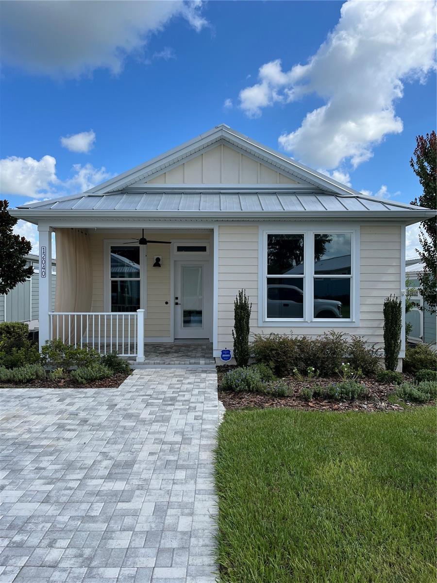 Move-In Ready! or Investors Owner will lease back for 6 months!
Welcome to the Captiva Model, a bright, charming, modern cottage-style home designed with high quality features providing comfort, functionality, and a relaxed lifestyle. The Captiva offers incredible indoor-outdoor living with a front and rear porch. If you enjoy hosting company, this is the model for you! Unique split bedroom floor plan.
Open kitchen with large eat-in bar and abundance of storage with Oversized windows throughout.
Located in Lakeshore, a serene Simple Life Community in Oxford, Florida, this home sits on Lake Andrew with conservation views, right on the western edge of The Villages. Lakeshore blends the charm of a hybrid cottage-style community with a mix of site-built and manufactured homes, offering something for everyone.
The community boasts an impressive range of amenities, including: A state-of-the-art clubhouse, Multi-purpose fitness room, Swimming pool and pickleball courts, Scenic walking trails and a fishing pier, Relaxing fire pit and garden area, Dedicated dog park …
Don’t miss this opportunity to own a move-in-ready model in a sought-after location. Schedule your visit today and experience the Lakeshore lifestyle before these homes are gone!