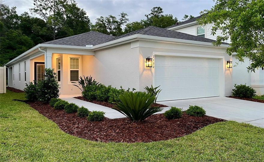 Welcome to Canopy Terrace, one of DeLand Florida's newer neighborhoods. Canopy Terrace is located in one of West Volusia's Premier locations, less than 45 minutes to Florida's finest beaches, Orlando and all the Attractions, with only a short drive to Daytona International Speedway. This 4-bedroom Daniel Model built by Pulte Homes in 2023 was upgraded by the owner with over $30,000 of high-end improvements. This is a rare opportunity to experience unparalleled luxury in this newly built, meticulously upgraded 4-bedroom, 2-bath residence. Every detail has been thoughtfully elevated; from the moment you step through the grand leaded glass entry door. The Home is located on the Eastside of the neighborhood which backs up to woods for additional privacy. This extremely well-kept home is move in ready. The focal point of the Open Floor Plan is the gourmet kitchen that is a chef's dream, featuring enhanced cabinetry with crown molding, sophisticated hardware, designer pendant lighting, a stylish tile backsplash, and exquisite Level 3 granite countertops. The flooring is ceramic tile in all high traffic areas with Luxury Vinyl Planking in the bedrooms, which was one of the upgrades after the home was built.
This is a rare opportunity to experience unparalleled luxury awaits in this newly built, meticulously upgraded 4-bedroom, 2-bath residence. 

Retreat to spa-inspired bathrooms, where modern single-lever faucets and upgraded hardware elevate daily routines. The primary suite offers a custom-tiled shower encased by a frameless glass door with a protective coating for effortless maintenance, alongside optimized closet storage.

Enjoy the convenience of advanced whole-home wireless connectivity, remote-controlled DC motor ceiling fans, and a smart garage door accessible via app. Outside, rust-proof carriage lights enhance curb appeal, rain gutters provide practical elegance, and the pristine epoxy-coated garage floor adds another touch of refinement.

This exceptional home offers a serene backdrop, backing directly onto a large, wooded area, ensuring privacy and natural beauty. Discover the elevated lifestyle awaiting you. Schedule your private tour today.
