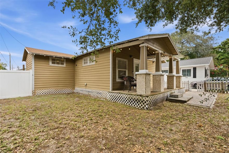 One or more photo(s) has been virtually staged. This 2-bedroom, 2-bath home in sought-after Seminole Heights offers a comfortable layout with high ceilings and a bright, open feel from the moment you walk in. The main living space easily accommodates both a sitting area and dining setup and flows into a stylish open kitchen featuring crisp cabinetry, granite countertops, stainless steel appliances, and excellent natural light for a clean, contemporary feel. The kitchen also offers plenty of cabinet storage, and the home includes a washer and dryer for added convenience. French doors from the kitchen open to the backyard, making it easy to enjoy indoor-outdoor living.

Durable, high-quality laminate flooring runs throughout the home, offering a clean, modern look. The primary bedroom includes a beautifully updated en-suite bath featuring a custom tiled walk-in shower with glass enclosure, decorative mosaic accents, a built-in shower niche, and modern fixtures for a polished, spa-like feel.

Out front, you’ll love the spacious covered porch—a perfect spot to unwind or gather with friends—plus the convenience of a private driveway for easy parking. Out back, a sizeable privacy-fenced yard gives you room to relax or entertain, and the detached garage provides great extra storage. Set on a desirable corner setting, the home offers extra outdoor space and added privacy.

Ideally located near Seminole Heights dining and coffee spots, with quick access to Downtown Tampa, Armature Works, Hyde Park, major shopping and restaurants, Raymond James Stadium, and Tampa International Airport.

One or more photo(s) has been virtually staged. Available now — Contact the Listing Agent with any questions.