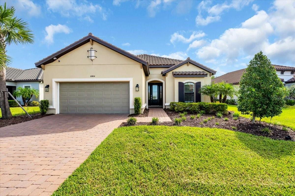 Welcome to resort-style living in Esplanade at Artisan Lakes, where every day feels like a vacation. Built in 2022, this 3-bed/3-bath home sits on a serene conservation lot with no backyard neighbors and was designed for effortless indoor-outdoor entertaining. The heart of this home opens to a covered lanai with a fully equipped outdoor kitchen and a heated, salt water pool with a spa, creating a private retreat framed by preserve views. Inside, the split-bedroom layout offers privacy for guests, while the open great room and chef's kitchen keep everyone connected. Life behind the gates of Esplanade at Artisan Lakes offers you a state-of-the-art fitness facility, locker rooms, and event spaces with a catering kitchen. A full-time lifestyle director organizes events, clubs, and activities. Outdoors you'll find tennis, pickleball and bocce courts, a resort-style pool with cabanas, a hot tub, a resistance pool, and a fire pit. Nature lovers can enjoy walking trails, dog parks, a playground, and a butterfly garden. The Venue, a second amenity center, features an additional pool and hot tub, as well as an indoor gathering area for games, club meetings, and entertainment. HOA fees include cable TV, internet, yard maintenance, and irrigation, ensuring convenience and low-maintenance living. With quick access to I-75 and I-275, this home is ideally situated between Sarasota, St. Petersburg, Tampa, and the Gulf Coast beaches.