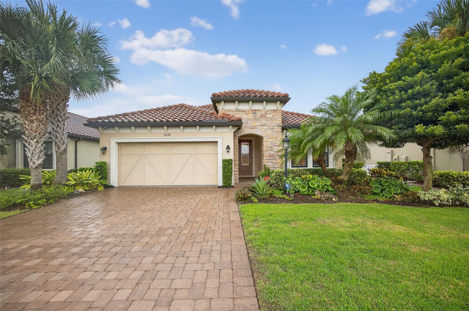 Impeccably Upgraded Piceno Model | 2BR + Den | Outdoor Oasis & Designer Touches! Welcome to this beautifully upgraded 2-bedroom, 2-bath Piceno model featuring thoughtful design, high-end finishes, and exceptional indoor-outdoor living. The gourmet kitchen is a true showstopper with an oversized Cambria quartz island offering extra storage, a custom pantry, stainless steel LG appliances, built-in desk, wine fridge, and under-cabinet lighting. Ideal for entertaining or everyday living, it seamlessly connects to the open-concept great room with tray ceilings, built-in surround sound (indoors & outdoors), and Hunter Douglas motorized shades on the sliders. Step outside to your extended lanai oasis featuring newer pavers, Storm Smart roll-down shades, and a fully equipped outdoor kitchen with granite countertops, built-in grill, side burner, sink, fridge, and ice chest—perfect for hosting guests or unwinding in peace. The spacious primary suite boasts dual custom walk-in closets, Cambria quartz dual vanities, and a luxurious walk-in shower. Ceramic tile flows through the main living areas, while both bedrooms feature plush carpet and plantation shutters. The private den offers double French doors, LED lighting, custom built-ins, and interior roll-down shades—ideal for a guest space or home office. The laundry room is both functional and stylish with built-in cabinetry and an LG front-load washer & dryer with pedestals. Major systems are move-in ready with a new A/C and water heater (2023), whole-house generator, Ring doorbell, motion-sensor lighting, and full alarm system. The garage impresses with epoxy flooring, custom cabinets, workbench, and overhead storage. Ceiling fans throughout complete the comfort-focused upgrades. THIS IS A NON-GOLF HOME. Esplanade offers a wide array of amenities and activities such as an 18-hole championship golf course, two resort pools, hot tubs, resistance pool, pickleball, tennis, bocce ball, two fitness centers, exercise classes, two dog parks, firepit, spa/salon, an on-site lifestyle director, social events, and various clubs plus a Tiki bar. The state-of-the-art Culinary Center offers residents several dining options such as the Barrel House as well as catering services, wine tastings, and special events. THE CHANDELIERS IN THE FOYER AND DINING ROOM, THE WHITE SHELVING IN THE FAMILY ROOM DO NOT CONVEY. This home is the perfect blend of style, function, and peace of mind—schedule your private tour today. There are camera at the front door and on the lanai.