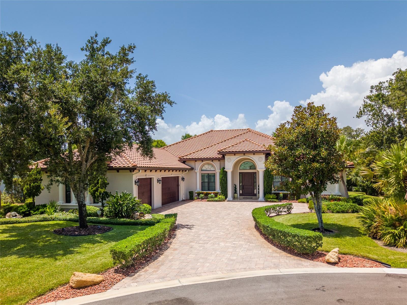 Welcome to an exquisite home on a quiet cul-de-sac in the upscale 24-hour guard-gated community of Hammock Dunes. Experience the pinnacle of luxury living in this 3,984 sq ft custom-built residence that sits on just over a half-acre. It has 3 bedrooms, 3.5 baths, and a versatile den/office. From the moment you arrive, you’ll be captivated by its impressive curb appeal and that will set the tone for the exceptional interior design.
Step inside to witness architectural sophistication and soaring coffered ceilings that add depth, character, and a sense of grandeur to each living space. The formal living and dining rooms provide ample space for entertaining, highlighted by a gas fireplace and custom niches for a refined, open feel. Just off the grand foyer, you’ll find a spacious den/office featuring a custom built-in desk and bookcases. Perfect as a private workspace or library, this room offers exceptional versatility and can easily be transformed into a comfortable fourth bedroom. The expansive master suite offers a true private retreat with dual custom walk-in closets and a spa-inspired bath featuring an oversized walk-in shower and soaking tub for the ultimate relaxation. The family room off the kitchen has a distinctive wood ceiling, built-in wet bar, 2 wine refrigerators, custom bookshelves and a gas fireplace which will add warmth to the living areas.
The chef kitchen is a culinary dream, showcasing high-end custom cabinetry, granite countertops, center island, premium appliances, and abundant pull-out storage. The expansive windows across the rear of the home fill the interior with natural light while framing serene conservation views throughout the home. Thoughtfully designed for privacy, this home offers separate guest quarters with a private lanai entrance. This space offers the ideal balance of comfort and privacy for guests or extended family. If the inside of the house was not enough, step out to your outdoor private oasis – a screened-in outdoor kitchen and lanai overlooking the peaceful conservation area.
Completing this exceptional property is an oversized 3-car garage with ample space for storage, a 250-gallon buried propane tank, a whole house water filtration system, home security system, and a built-in wall safe for all your personal items. No detail was left undone.
Beyond the home, the Hammock Dunes lifestyle offers an extraordinary blend of relaxation and recreation. While membership to Hammock Dunes Club is optional, it unlocks a world of amenities, including: two Audubon-certified championship golf courses designed by Tom Fazio and Rees Jones, two clubhouses, formal and casual dining, fitness center with group classes and personal training, pool and splash pad, tennis, pickleball, bocce and amazing croquet courts overlooking the ocean.
Homes of this caliber are rare—don’t miss your chance to own this one-of-a-kind residence in one of Florida’s premier private coastal communities.
