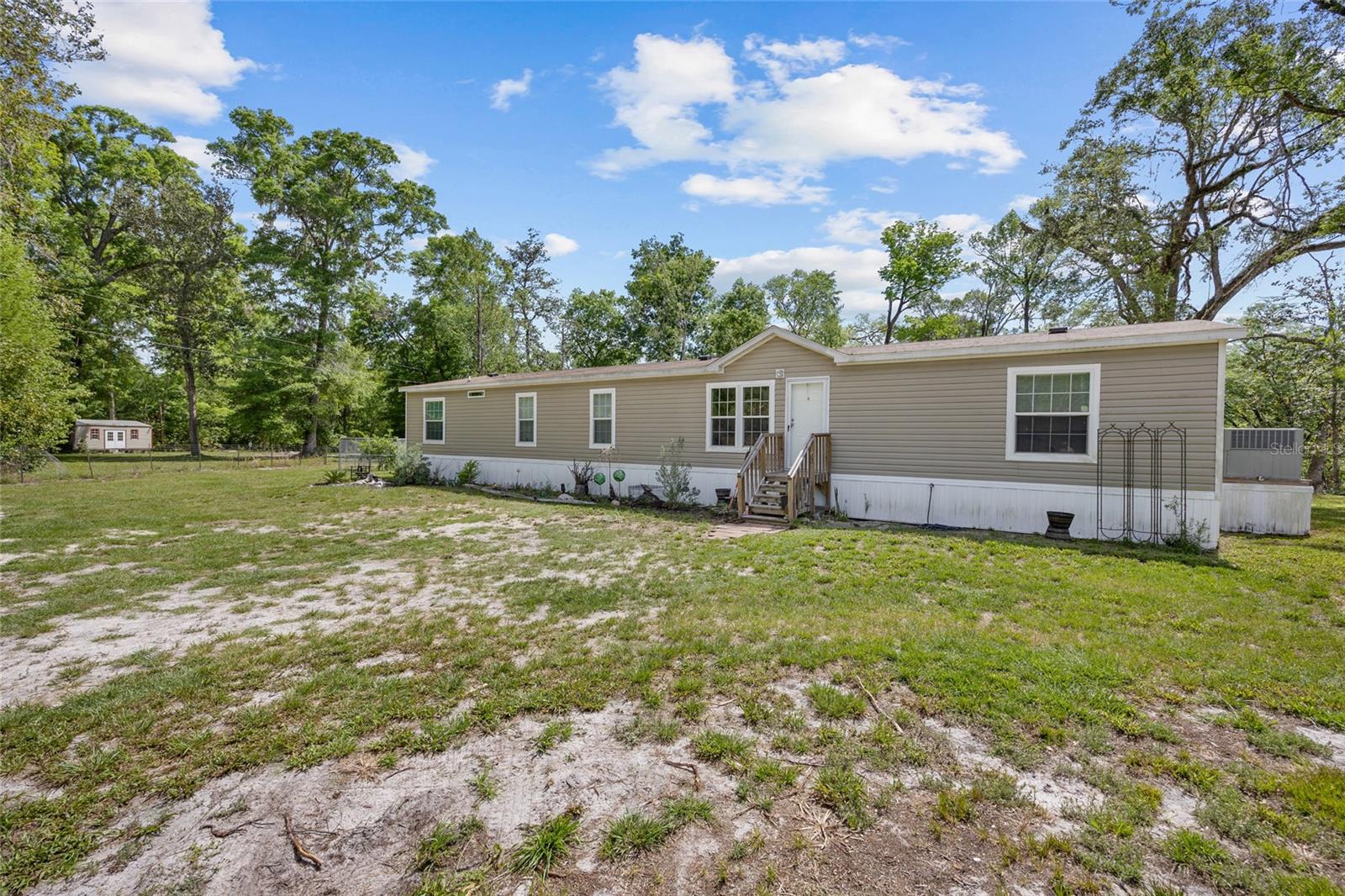 Welcome to your riverfront retreat on the Santa Fe River, where Old Florida beauty meets modern comfort and endless adventure. Nestled just outside Branford, FL, this extraordinary 4-bedroom, 3-bathroom home includes a dedicated office space, making it ideal for families, outdoor enthusiasts, or those seeking a serene work-from-home sanctuary. Set on a rare piece of land perched above the 500-year floodplain, this property offers peace of mind along with stunning natural surroundings. The land is steeped in history—a registered archaeological site rich with discovered artifacts, echoing the stories of generations past. You won’t just be purchasing a home—you’ll be becoming a steward of a truly historic piece of Florida. Outdoors, the property stuns with features designed for leisure, recreation, and reflection. Step out onto your aluminum floating dock and cast a line into the clear, spring-fed waters of the Santa Fe River—famous for world-class freshwater fishing. Paddle your kayak at sunrise, hop on your boat for a relaxing cruise, or dive into the depths for incredible scuba diving experiences in the nearby springs and river caverns. The Santa Fe River also serves as a gentle highway for manatees, who migrate through its waters to access the over 100 springs that feed the river year-round. Back on land, a custom-built gazebo, handcrafted by skilled Amish woodworkers, offers a shady haven for morning coffee or evening gatherings while you listen to the gentle rustle of leaves and flowing water. The Amish-built barn is equally impressive, offering space for equipment, storage, or conversion into additional functional or recreational areas. Whether you’re operating a small business or simply love to garden, the property's current use as a licensed nursery provides exciting potential and plenty of space for expansion. The natural landscape is a showcase of Old Florida charm, dotted with majestic native trees, including an awe-inspiring live oak estimated to be over 400 years old. You'll also find flowering southern magnolias, persimmons, sweet gums, and a lush, biodiverse understory that supports abundant wildlife. As you explore the grounds, you’re likely to encounter white-tailed deer, playful river otters, majestic bald eagles, and two species of wild turkey. Every season brings new sights and sounds—whether it's the flash of an eagle's wings overhead, the gobble of turkeys at sunrise, or the soft splash of a manatee surfacing in the river. Inside the home, you'll find a warm and inviting layout with four spacious bedrooms, three full bathrooms, and a versatile home office perfect for remote work or creative pursuits. Large windows throughout bring the outdoors in, offering peaceful river and forest views from nearly every room. The kitchen, dining, and living areas are thoughtfully designed for both family life and entertaining, with practical finishes and an easy flow. Whether you're looking for a private residence, a riverside retreat, or a unique business opportunity, this one-of-a-kind property offers it all—natural beauty, rich history, and unmatched access to the water. Don't miss your chance to own a slice of paradise where Florida’s wild heart still beats, and the river always calls. Schedule your private tour today and experience the magic of life on the Santa Fe River.