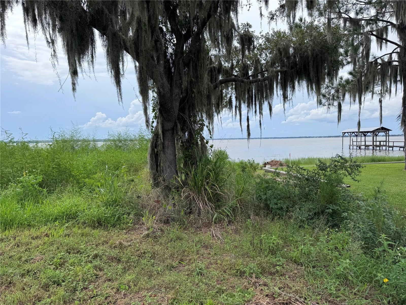 Lakefront Lot on Lake Reedy-1.27 Acres- Discover your own slice of paradise on the shore of stunning Lake Reedy, a sprawling 3600 acre lake renowned for it boating, fishing and even FAA-approved water landings for airplanes. This 127 acre lakefront property offers breathtaking sunset views, with majestic trees providing shade and privacy along both the road and shoreline. Whether you're looking to build your dream home, create a private retreat, or enjoy year-round outdoor recreation, this rare property offers it all. Imagine relaxing evenings by the water, fishing at sunrise, or watching planes gracefully land and take off right from your back yard. Don't miss this opportunity to own prime lakefront acreage on one of the area's most beautiful and versatile lakes.