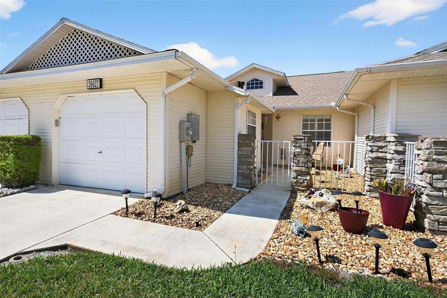 Welcome to 26627 Racquet Circle-located in the premier 55+ gated community of Highland Lakes! This move-in ready villa features a bright open floor plan with two spacious bedrooms, both fully equipped with ensuite bathrooms-refreshed with updated toilets. Major updates provide peace of mind, including a new Roof (2022), a new garage door opener and keypad, and a well-maintained A/C (2014). The interior shines with newer Luxury Vinyl Plank flooring throughout, fresh interior paint, and newer countertops in both the kitchen and bathrooms. The heart of the home is the kitchen with its convenient breakfast bar, while new light fixtures and fans in both bedrooms add a modern touch. Enjoy the best of Florida living in the light-filled Florida room, or relax on the rear outdoor patio. The front courtyard is fully fenced-in, offering a private and secure entry-perfect for your pets! This home comes complete with a new washer and dryer for added convenience. For an added bonus, lawn maintenance and irrigation are included in the HOA! HOA/COMMUNITY: Highland Lakes is located in the “Lakefront City” of Leesburg, and features a plethora of amenities, including a clubhouse, heated indoor pool, outdoor pool, fitness center, bocce ball, pickleball, tennis, library and so much more! Highland Lakes is located off the U.S. Highway 27, just minutes from beautiful local destinations-Venetian Gardens Park and downtown Leesburg! Easily commute to The Villages’ restaurants and entertainment, Orlando theme parks, Ocala National Forest, and Mount Dora! Call to schedule your personal tour today!