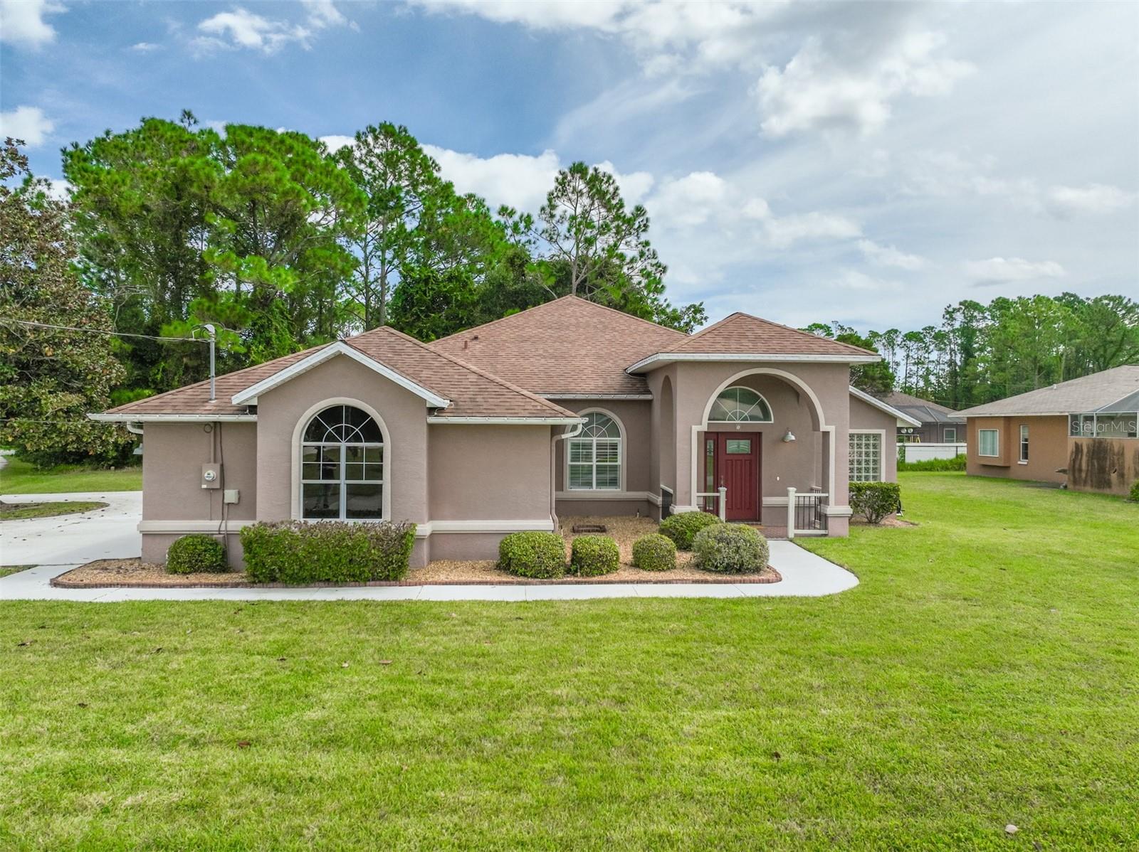 Beautifully maintained home situated on a desirable corner lot in the sought-after Pine Lakes community. This solid block residence offers 3 bedrooms plus an office, a thoughtful split floor plan, and a seamless flow between the living spaces. The spacious primary suite features private patio access, a large walk-in closet, and a fully renovated bathroom with a soaker tub and walk-in shower. The kitchen opens to the dining area, living room, and breakfast nook, creating an inviting space for everyday living and entertaining. Enjoy the covered patio with charming brick flooring overlooking a private backyard. Additional highlights include tile and luxury vinyl flooring throughout, an interior laundry room with washer and dryer included, and an easy-to-maintain layout. Just a few short minutes away from the Pine Lakes golf course, ample stores and beaches as well as I-95, US-1 and the new hospital. A wonderful opportunity to own a move-in ready home in Pine Lakes. Schedule your private showing today!