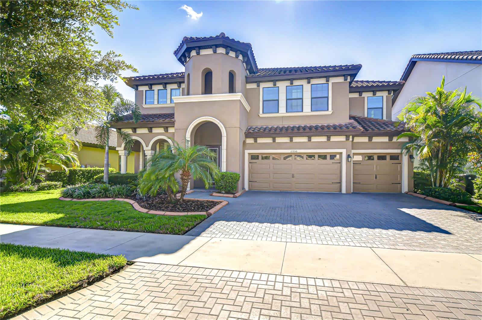 Located in the prestigious, family-friendly, and gated community of Hawks Fern, this Home by WestBay is a breathtaking blend of luxury, space, and thoughtful design. Perfectly crafted for multi-generational living, this exceptional residence offers an in-law suite with kitchenette on the main level. Its prime location—backing up to FishHawk West, top-rated schools, and serene conservation land—makes it a truly one-of-a-kind home. From the moment you step through the grand double-door entry, you’re welcomed into a well-designed layout that balances style and practicality. The entryway showcases beautiful wood-look tile floors throughout, and you can’t help but notice the beautiful backyard views. A private home office sits behind French doors, perfect for remote work or study, and a formal dining room stands ready for elegant gatherings. Beyond the foyer, the main living space unfolds into an expansive open-concept grand room, chef’s kitchen, casual dining area, and a covered lanai—creating a seamless flow that encourages connection and comfort. Anchoring the great room is a dramatic floor-to-ceiling stacked-stone gas fireplace (2023), effortlessly controlled by remote, adding warmth and character to the space. The chef’s kitchen features a large center island, high-end finishes, and ample room for meal prep, entertaining, and everyday living. Designed with adaptability in mind, this home includes a versatile downstairs bonus room, thoughtfully converted into a fully functional kitchenette with a refrigerator, cabinetry, and sliding barn door—creating a private in-law suite complete with its own bedroom, bathroom, and walk-in closet. Upstairs, a spacious loft offers additional flexible living space with sliders to the upstairs balcony and includes a custom 10-foot built-in storage bench (2023), perfect for organization or display. The stairs and parts of the upper level have been upgraded to luxury vinyl plank flooring (2025), offering both beauty and durability. The primary suite sits behind French doors and features balcony access, a private en-suite with separate shower, tub, and dual vanities, and a HUGE walk-in closet the size of an additional bedroom—nothing short of amazing. Two additional bedrooms share a Jack-and-Jill style bathroom, while a fourth upstairs bedroom is tucked away in a private wing, complete with a massive walk-in closet and full bath. The upstairs laundry room is designed for convenience with added cabinetry and an extra fridge. Additional upgrades include crown molding throughout the main level and primary suite/bathroom (2019), plantation shutters for timeless elegance and privacy (2019), and a double balcony with serene views of the backyard and conservation area—no backyard neighbors in sight. The garage has also been upgraded with durable epoxy floors and multiple ceiling-mounted storage racks—providing both function and style for organization and utility. This stunning home truly has it all: luxury features, smart updates, functional living spaces for every generation, and an unbeatable location in one of the area’s most sought-after communities.