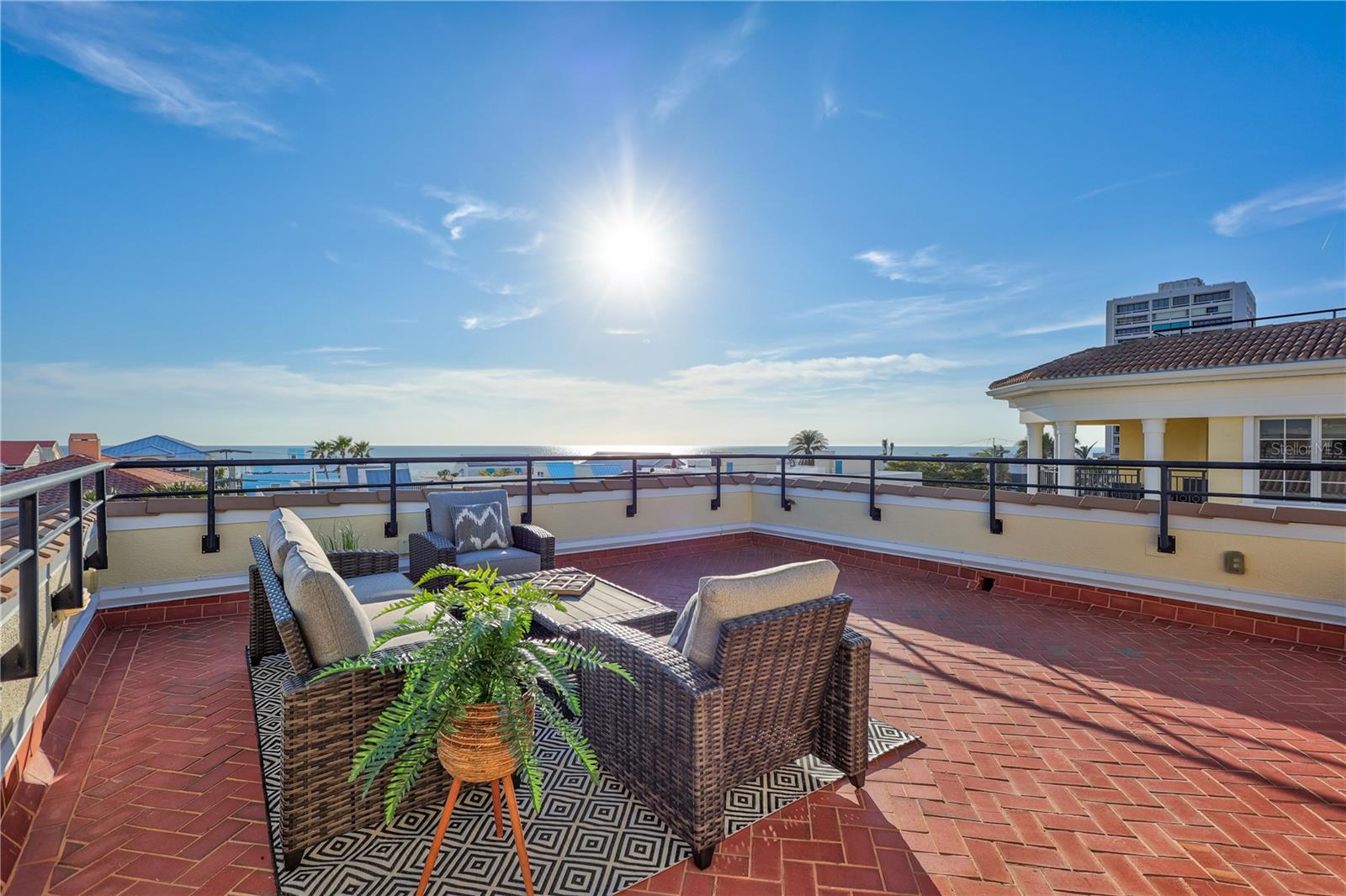 ONE-OF-A-KIND IN THE HEART OF SIESTA KEY! With more than 3,300 square feet of beautifully designed living space, this meticulously maintained 4-bed, 3.5-bath single-family home is move-in ready and available for a quick close, as it sustained NO storm damage. From the moment you arrive, the classic architecture, tile roof and detailed craftsmanship are bound to leave a lasting impression. The gated entrance opens to a paver brick driveway, leading to TWO oversized 2-car garages separated by an elegant entryway leading to the foyer which features both an elevator as well as a travertine staircase for seamless access to all three floors. Throughout the entire home, you'll find light-filled living spaces, travertine flooring, towering 10-foot ceilings, 8-foot solid wood doors, tray ceilings creating an open airy ambiance, and floor-to-ceiling windows bringing in an abundance of natural light. The chef’s kitchen is a stunning fusion of elegance and functionality, outfitted with top-tier Wolf, Sub-Zero, and Fisher & Paykel appliances. A sprawling granite island with breakfast bar is ideal for casual dining or lively conversation. Designed for both culinary excellence and connection, the open-concept layout ensures you remain engaged with guests, offering seamless sightlines to the living and dining areas and extending to the balcony, where serene views of the private heated pool await. The master suite offers a tranquil retreat with its own private balcony, and spa-like bath featuring a deep soaking tub, walk-in shower with upscale finishes, and dual vanities. The lower level includes a spacious family and game room, with its own balcony ideal for entertainment or quiet lounging. There are three additional bedrooms on this floor, two full baths and two additional balconies creating plenty of inviting spaces for family and friends to relax and unwind. Outdoor living is truly exceptional, featuring a heated saltwater pool and spa for year-round enjoyment. The crown jewel of this home is the rooftop terrace, spanning over 1,000 square feet, it offers breathtaking 360-degree panoramic views, stretching from the Gulf of Mexico to Lido, Longboat, and downtown Sarasota. Whether hosting a sunset gathering, grilling your favorite meal, or watching the sun set with a glass of wine, this rooftop retreat offers an experience like no other. Every detail of this home has been thoughtfully designed for convenience and efficiency. A whole-house water filtration system. Impact windows and doors. The oversized garages, with two separate entrances, provide ample space for car enthusiasts, beach gear, or extra storage and an EV Charger. Practically in the heart of Siesta Key Village, you won’t have far to go for dining, shopping, entertainment and all the conveniences needed for an island lifestyle. Also just minutes from Sarasota's cultural attractions, as well as boating, fishing, golf courses and an abundance of professional sports venues. With no HOA restrictions and a projected gross rental income of $210k+ per year, this property presents an exceptional investment. Whether you’re looking for a full-time residence, a vacation retreat, or an income-generating property, this home is truly one-of-a-kind. Don’t miss this rare chance to own a luxury coastal retreat in one of Florida’s most iconic beach destinations. Your Siesta Key dream home is waiting—schedule your private tour today!