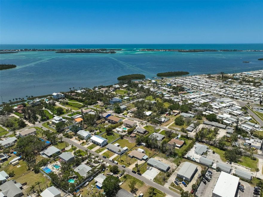 $20,000 PRICE IMPROVEMENT! Take advantage of this opportunity to transform the lot into a HIGH-PERFORMING INCOME PROPERTY or a PERSONALIZED COASTAL RETREAT! Uncover the beauty of this 3-bedroom, 2-bathroom home featuring classic terrazzo floors, a cozy fireplace, and an updated kitchen with new countertops and appliances. The spacious laundry room and enclosed porch add comfort and versatility to the layout. Roof replaced in 2018. The expansive backyard offers versatile potential—ample space to add a pool, accommodate RV or boat parking, or enhance with outdoor features to create an inviting oasis. Nestled near the historic Cortez Village, this one-of-a-kind property offers numerous avenues for creative development and utilization. With proximity to historic attractions, local seafood dining, and the vibrant Bradenton Beach Marina, this location offers an unmatched coastal lifestyle. The surrounding area features convenient access to parks, shopping, and highly rated schools, enhancing both daily living and long-term value. Whether you envision remodeling the existing structure or building a new duplex, the possibilities are plentiful! Don't miss out on this EXCEPTIONAL VALUE—schedule your showing today!