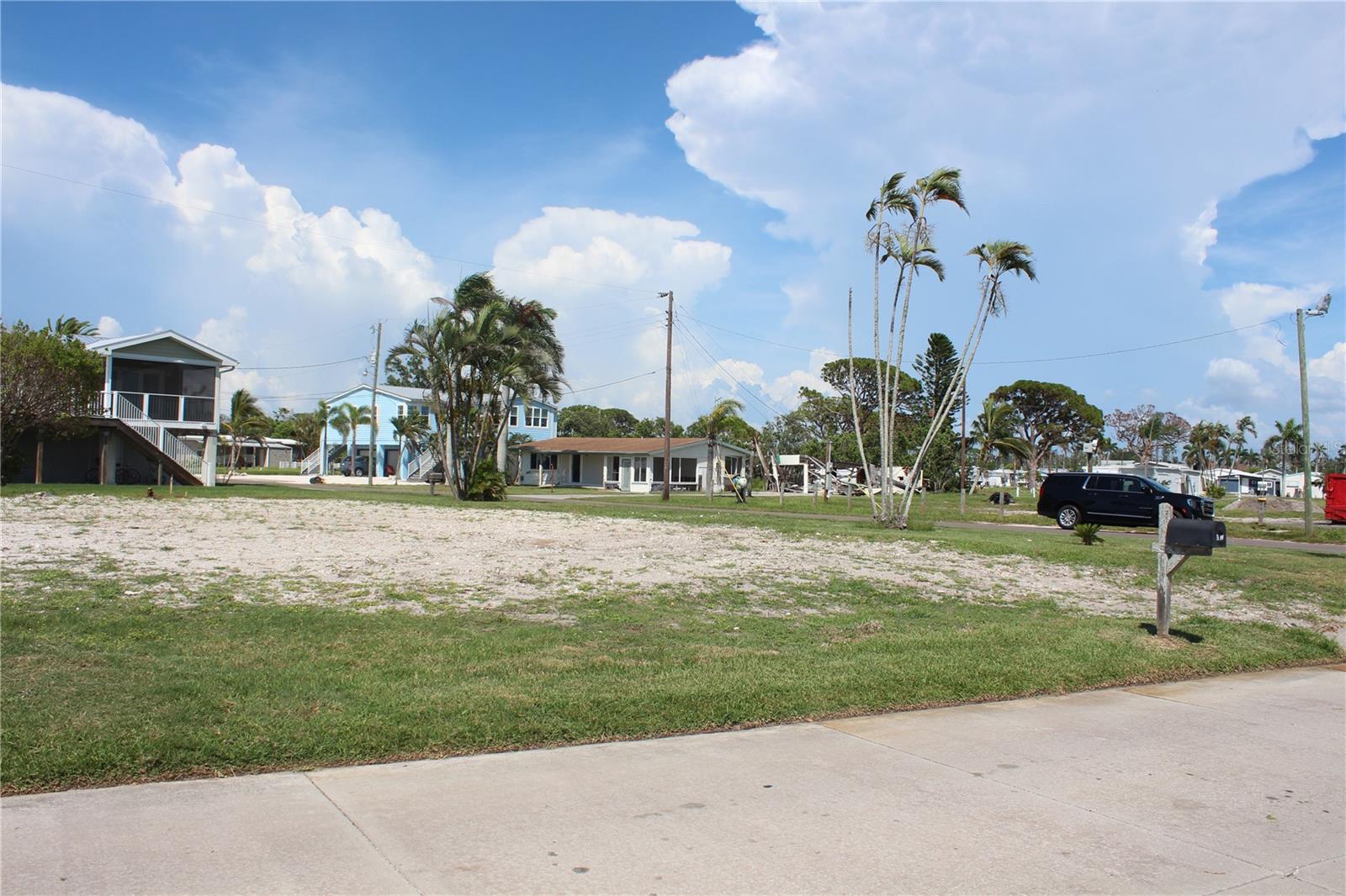 Build your dream home on this almost 1/4-acre prime corner waterfront lot facing SARASOTA BAY in the 55+ Community of Paradise Bay! This lot which comes in at 0.2301Acres or 10,024 sq ft AND is the most desirable lot available in this community. It sits on the corner of 106th St & Bayview Dr the kayak launch is conveniently located directly across the street. The Longboat Key Bridge in the distance is in direct sight lines & a covered gazebo is just steps away from your soon to be front door, complete with park benches & a bench swing to meet up with your neighbors to catch another remarkable sunset. Paradise Bay is a fun & active 55+ community with plenty of activities, such as pickleball, shuffleboard with spectator bleachers & bocci ball courts. For daily activities, just check out the bulletin board at the Recreation Center & go for a relaxing swim at the community pool. Several boat launches are throughout the community & boat slips are available to rent. You are a mere 5 minutes to Anna Maria Island to completely enjoy the Florida lifestyle. Also, for dining, you have your choice of quick serve restaurants to 5 star gourmet, plenty of golf courses, airports starting at a mere 20 minute drive, grocery stores, shops & boutiques. This area has everything you need to be pampered. Drone footage coming soon.