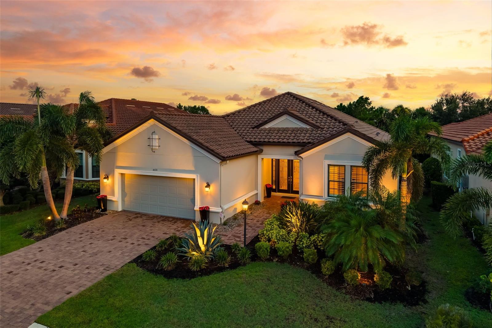 Nestled behind the gates of the prestigious Esplanade Golf and Country Club, ideally situated on the 1st tee of the championship golf course, this stunning Pallazio model offers a lifestyle of unmatched luxury and thoughtful design. With 3,077 sq ft under air, this home features 3 spacious bedrooms, a private den, and 3 full bathrooms, all designed with elegance and functionality in mind.
From the moment you arrive, the curb appeal captivates—featuring lush, mature landscaping and striking leaded-glass double doors that set the tone for what lies within. While the home appears to offer a 2-car garage, it’s actually a tandem 3-car garage—perfect for your cars, golf carts, or extra storage.
Inside, the open-concept layout welcomes you with soaring tray ceilings, custom crown molding, designer lighting, and a neutral color palette that provides a serene backdrop. The heart of the home is the gourmet kitchen, fully equipped with stainless steel appliances, custom cabinetry, gas range, wine cooler, solid quartz countertops, and a spacious island with bar seating that opens seamlessly to the great room—ideal for entertaining or relaxing in comfort.
Natural light floods the interior through expansive sliding doors, and all windows are dressed with plantation shutters for timeless elegance. The luxurious primary suite is a private retreat, with ample space for a sitting area or home office. The spa-inspired en suite bath features the latest finishes, and the walk-in closet is a dream with custom built-in shelving—ladies, bring all your shoes!
The two guest suites are both generously sized, offering comfort and privacy for visitors, each with access to its own full bathroom.
Step outside to your resort-style outdoor living area, where a fully equipped outdoor kitchen includes a grill, refrigerator, wet bar, icemaker, and trash receptacle. The sparkling pool with sun deck, chic Champagne spa, and ambient theatrical lighting create the perfect backdrop for evening entertaining or tranquil relaxation.
As a resident of Esplanade, you’ll enjoy access to a wealth of amenities:
• Championship 18-hole golf course with driving range, practice bunkers, and putting greens
• Tennis and pickleball courts
• Mediterranean-style resort pools with cabanas and poolside Bahama Bar
• The Barrel House restaurant – your social hub for fine dining and good company
• State-of-the-art wellness center offering fitness, yoga, and therapeutic spa treatments
Whether you're enjoying a peaceful evening at home or entertaining guests after a day on the links—this home offers the ultimate Florida lifestyle.
Welcome Home.