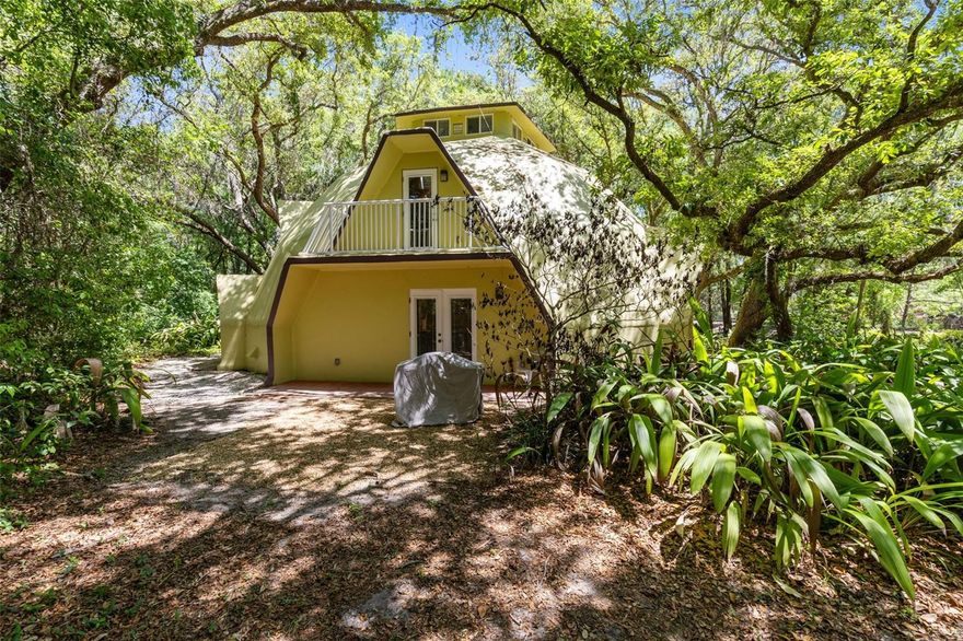 THIS PROPERTY IS BEING SOLD ALONGSIDE THE NEIGHBORING PROPERTY AT 5787 N APOPKA VINELAND ROAD, WHICH IS OFFERED AT $1,000,000—CREATING A RARE OPPORTUNITY TO OWN A UNIQUE, MULTI-PROPERTY COMPOUND IN A PRIME ORLANDO LOCATION. Welcome to 5789 N Apopka Vineland Road, a truly one-of-a-kind geodesic DOME home that blends architectural intrigue with everyday functionality, designed to withstand the harshest winds while delivering a living experience that’s anything but ordinary. Nestled beneath a canopy of mature trees and surrounded by lush, natural landscaping, the approach alone sets the tone—offering a private, serene setting with a charming front entry and inviting outdoor sitting area that feels like your own hidden retreat. Inside, you’ll find just under 2,600 square feet of open and flexible living space, featuring 3 bedrooms and 3 full bathrooms, with a spacious layout that seamlessly connects the living, dining, and kitchen areas—perfect for entertaining, hosting guests, or accommodating multiple uses. The expansive kitchen with bar seating flows effortlessly into the main living areas, while warm finishes and natural light create an inviting, comfortable atmosphere throughout. Major upgrades provide peace of mind, including a brand new HVAC system installed in 2024 and a new well installed in 2024. Situated on over an acre of agriculturally zoned land, this property offers incredible versatility—currently operating as a successful short-term rental, it can continue as an income-producing investment, serve as a long-term rental or in-law suite, or be transformed into a unique commercial space ideal for yoga classes, workshops, teaching, or a creative studio. Whether you’re looking to expand your investment portfolio, create a multi-generational living setup, or establish a one-of-a-kind business environment, this distinctive dome property—paired with the neighboring residence—offers endless potential in one of Orlando’s most desirable and accessible locations.